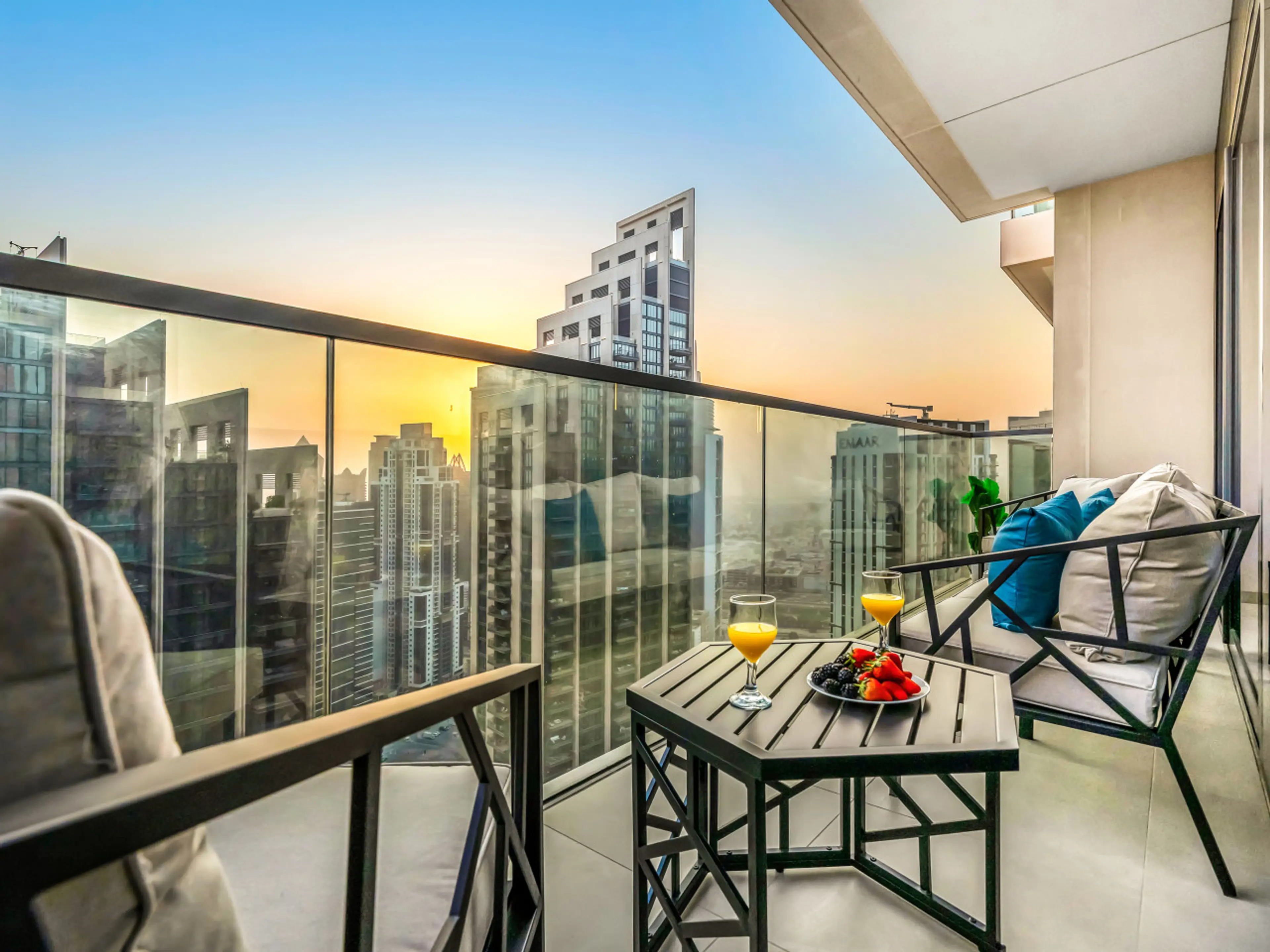 Private balcony with stylish outdoor furniture, offering stunning views of Downtown Dubai. Perfect spot to enjoy your morning coffee or a relaxing meal while overlooking the vibrant city skyline and iconic landmarks.