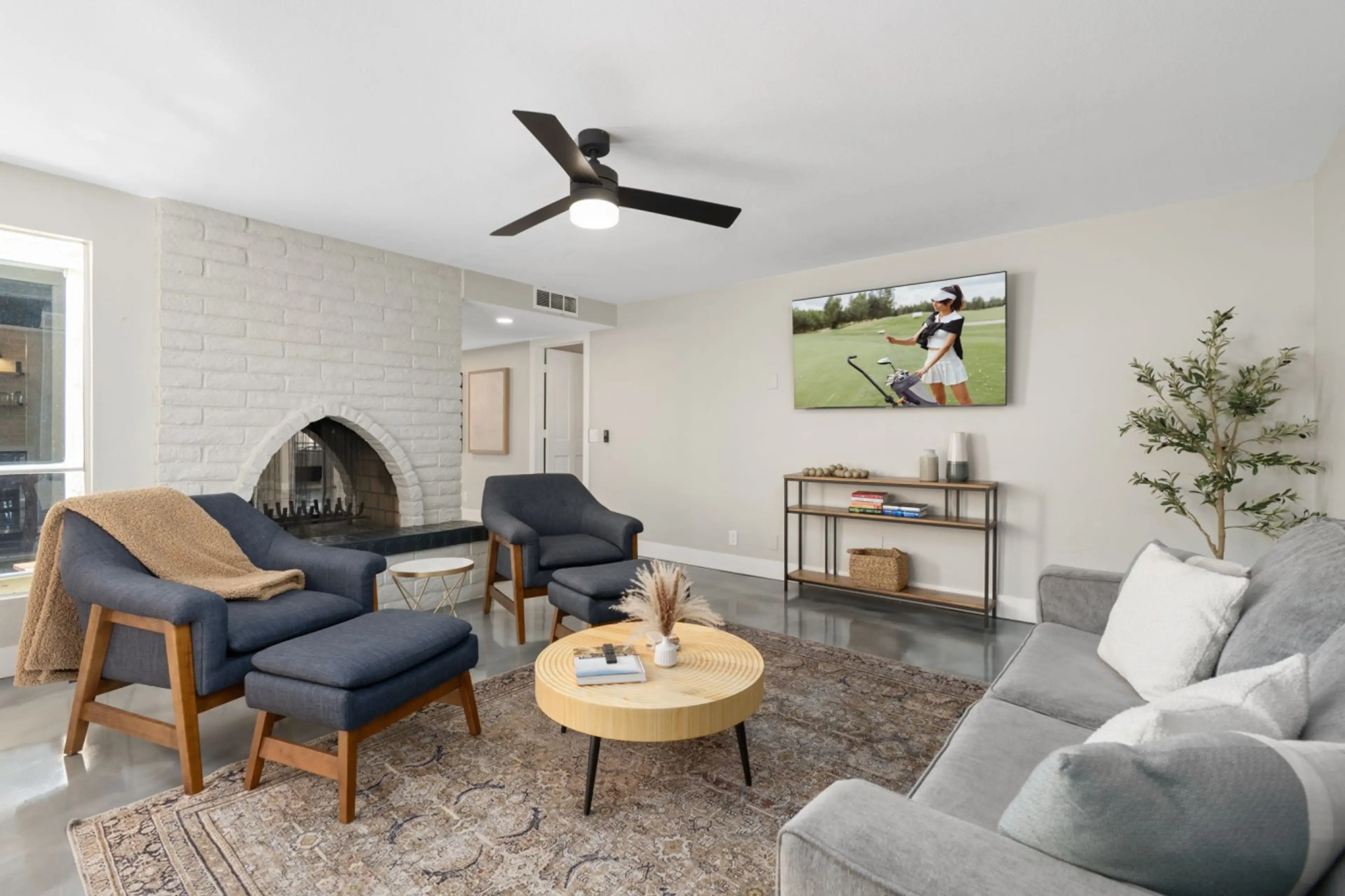 Gather around the fireplace in this comfortable living room with plenty of seating and a smart TV for entertainment.