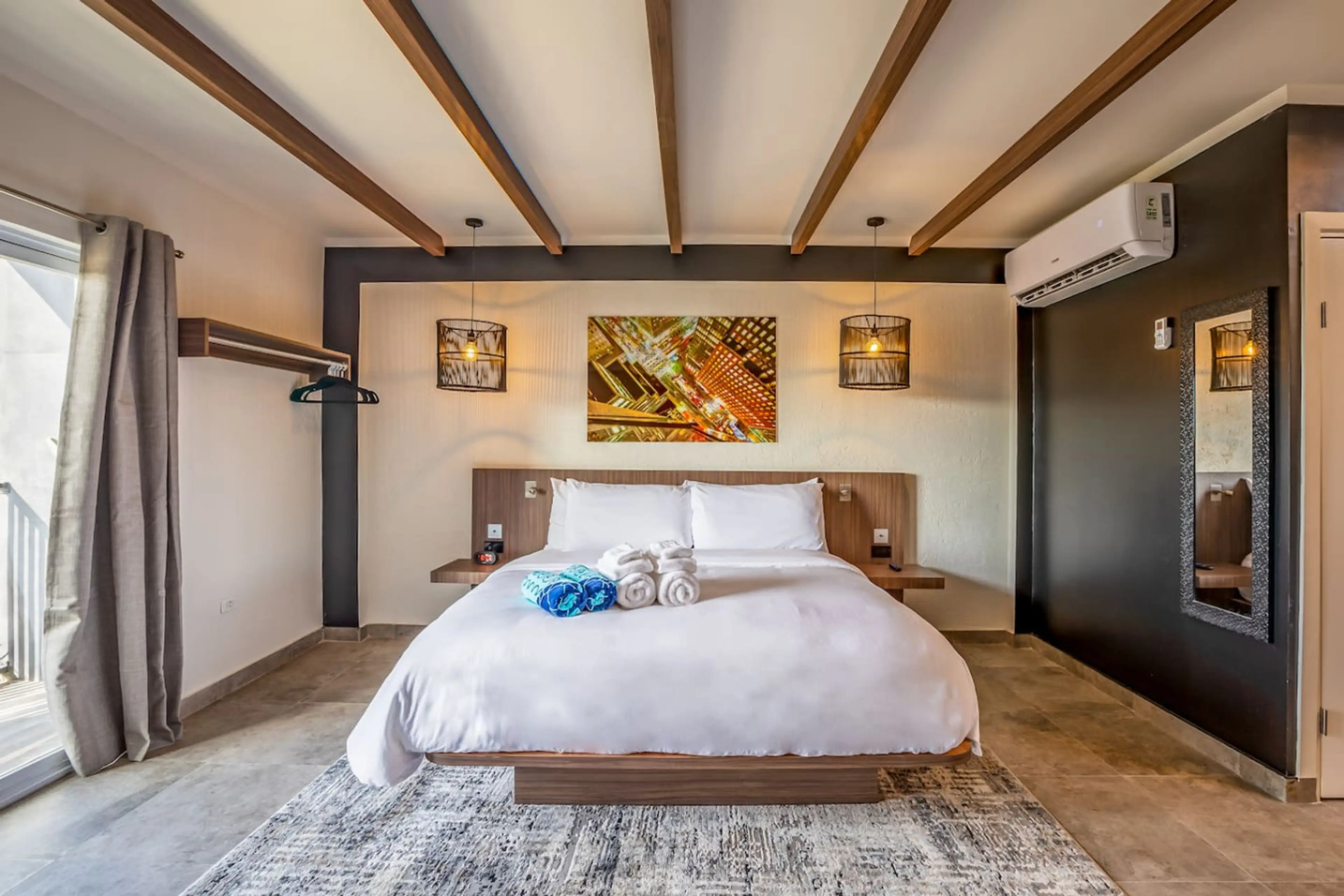 Cozy sleeping space accommodating up to 2 guests with a King-size bed. Adorned with four pillows for added comfort.