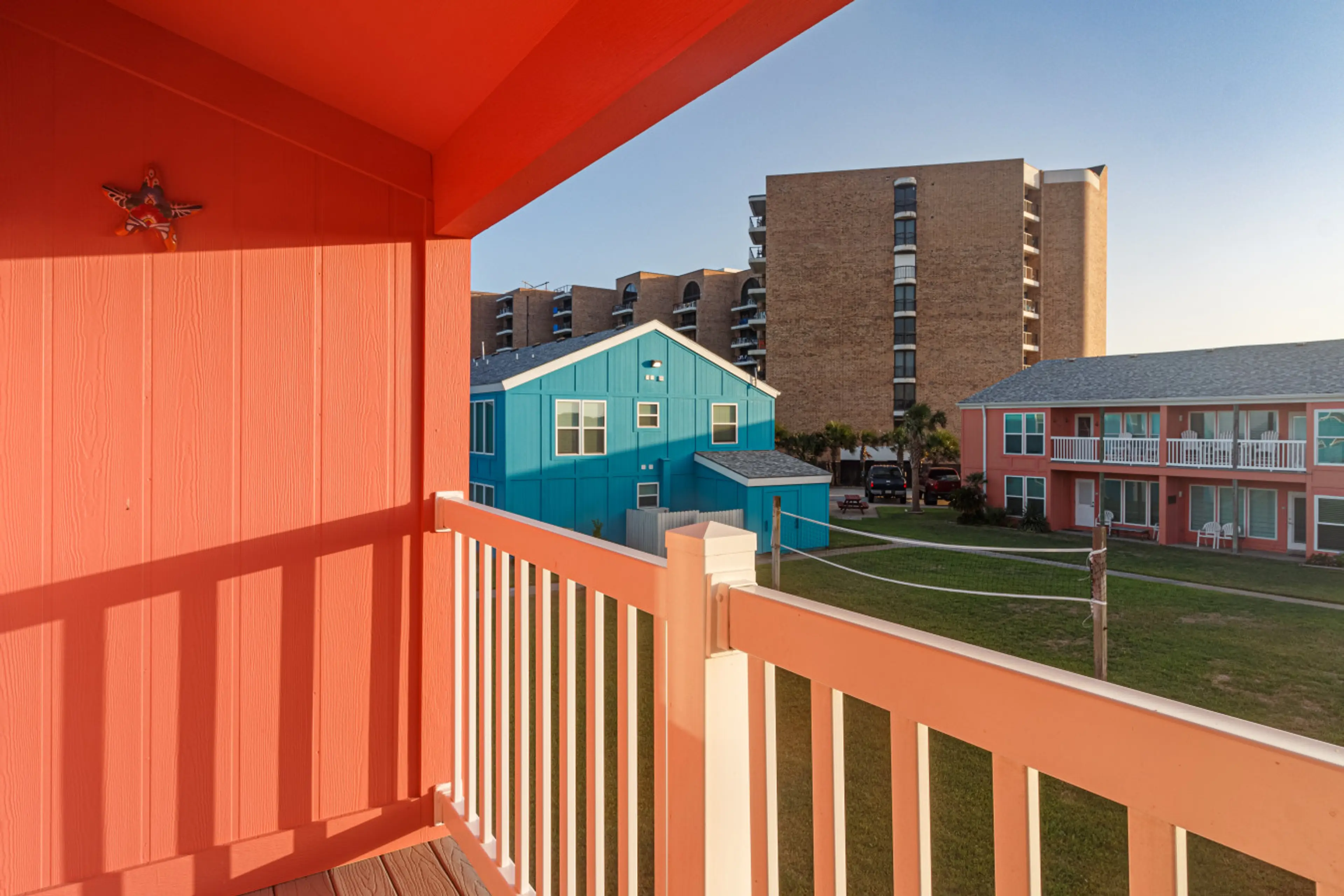 Private balcony overlooking colorful coastal condos