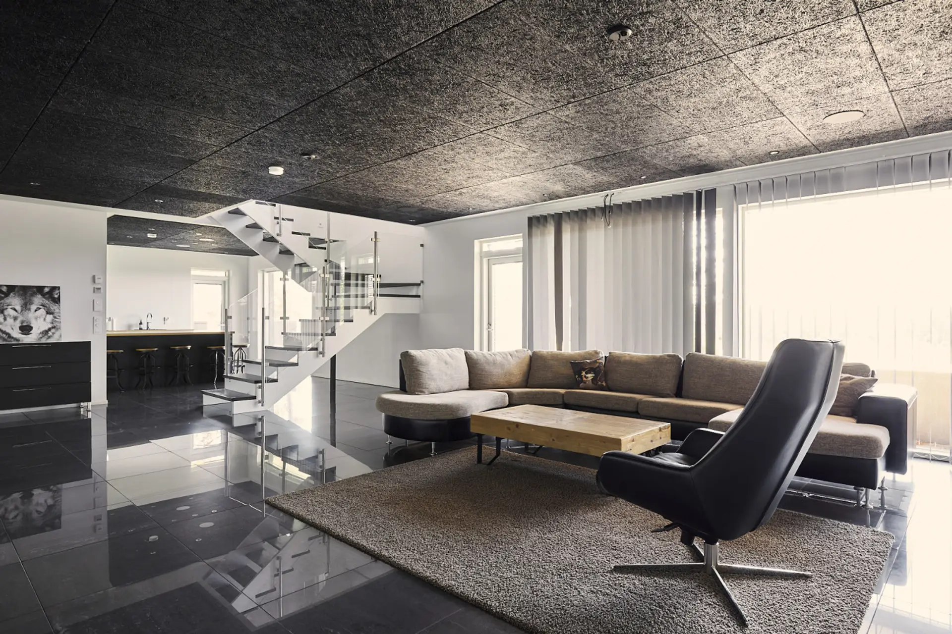 Stylish open-concept living room with floor-to-ceiling windows and stunning modern architecture.