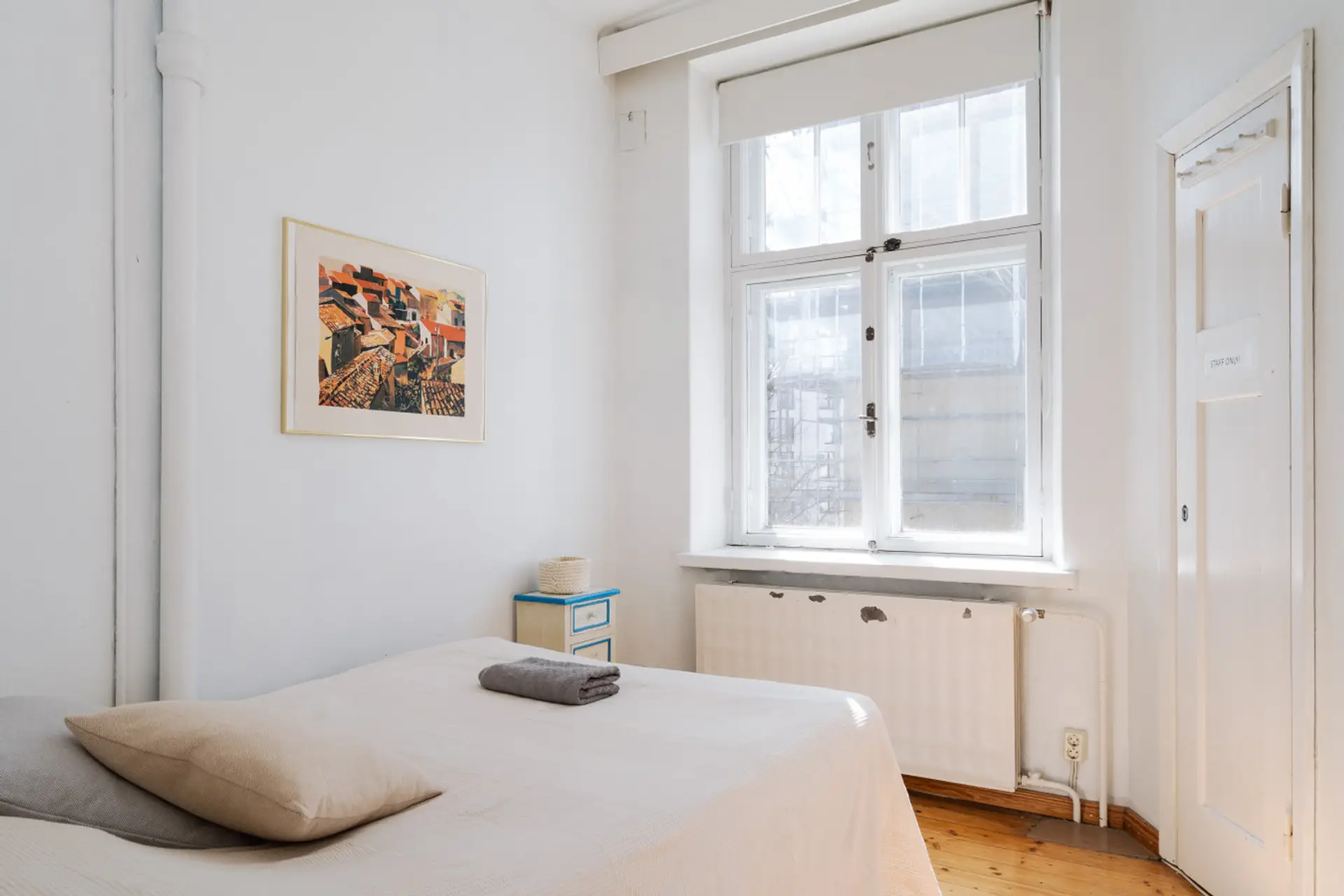 Wake up to soft, natural light filtering through large windows overlooking a quiet inner courtyard.