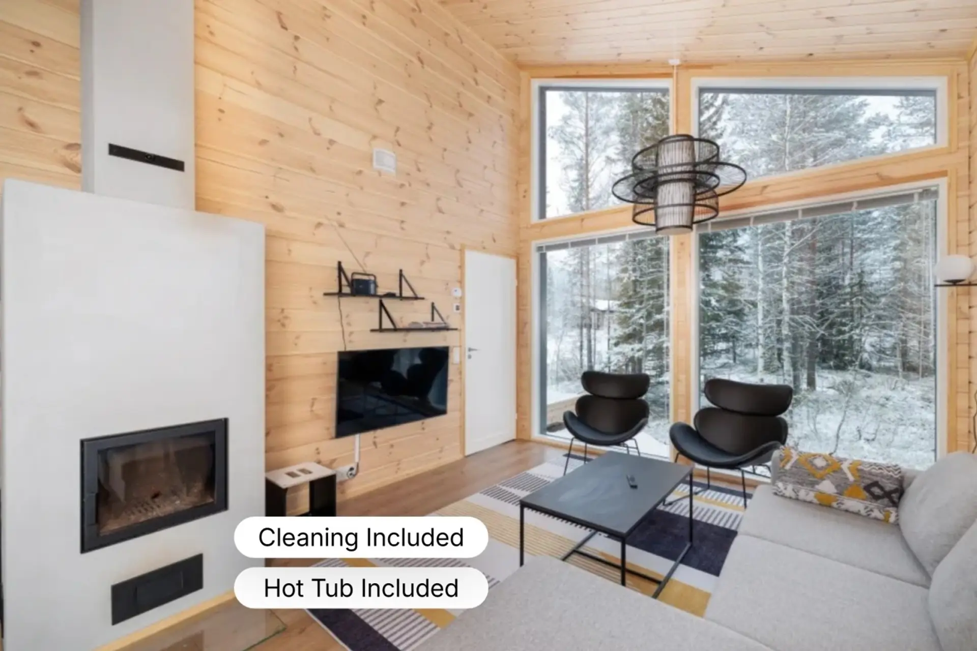 Relax by the warmth of the modern fireplace after a day on the slopes, with large windows offering a peaceful view of the surrounding Syöte forest.