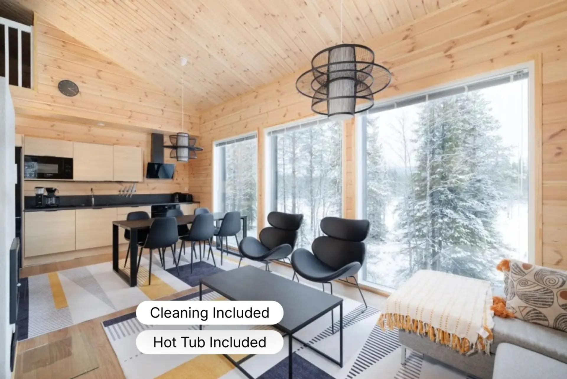 The open-plan living area features large floor-to-ceiling windows, allowing you to enjoy the snowy fell views and natural light while dining or relaxing.