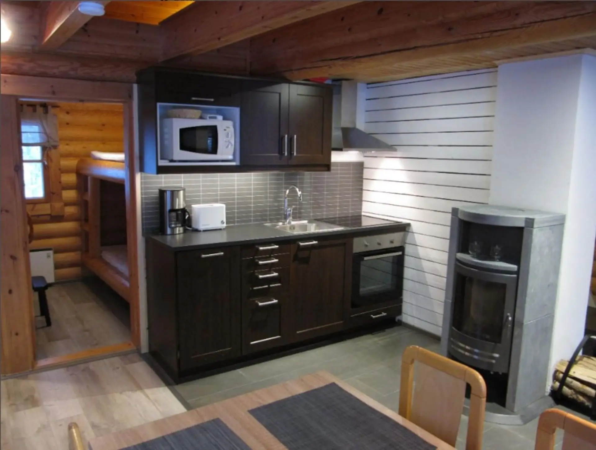 Fully equipped kitchen with an oven, microwave, kettle and coffee maker.
