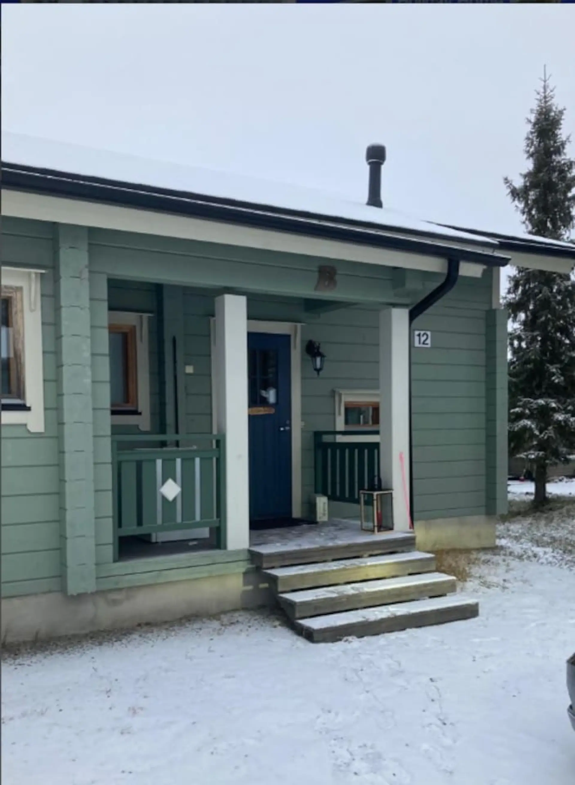 Covered entrance porch with steps leading up to the front door.