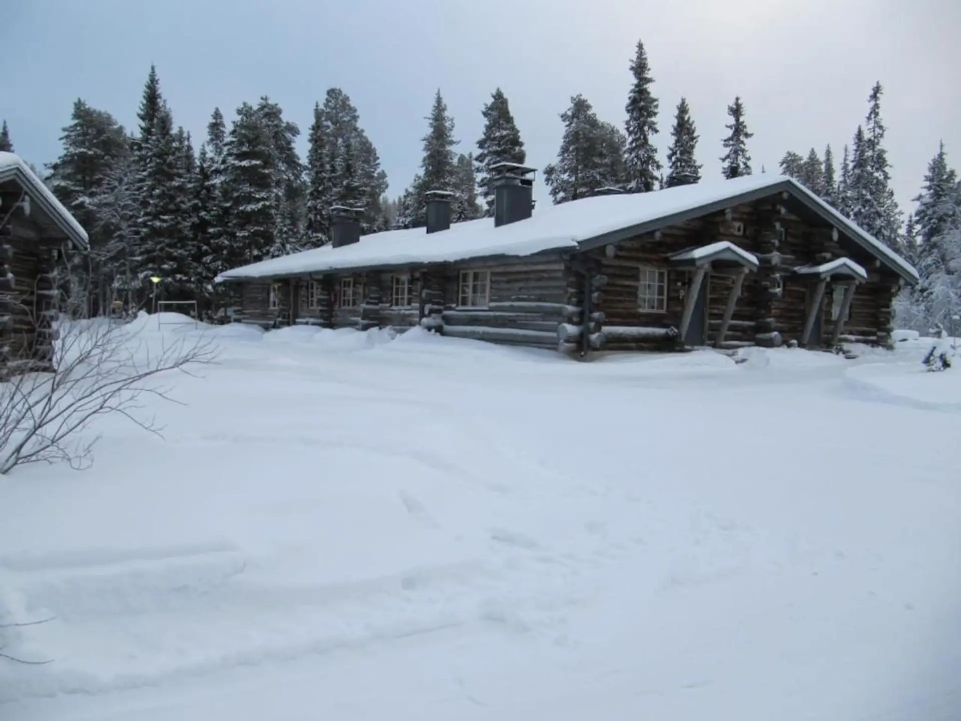 Exterior of the property blanketed in snow during the winter season.