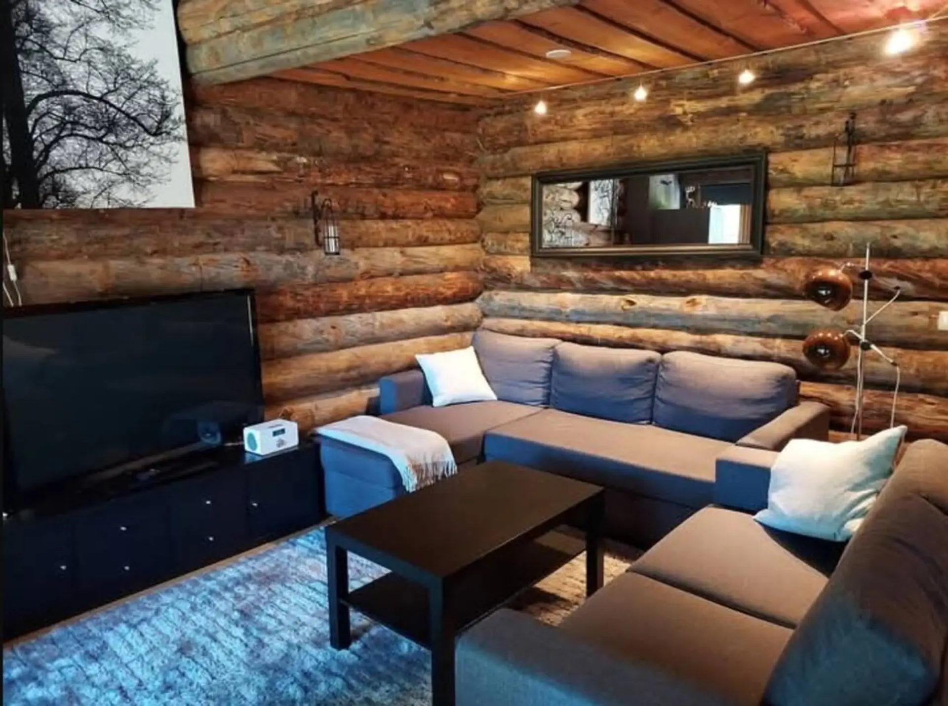 Spacious living room with a large corner sofa, coffee table and flat-screen TV.