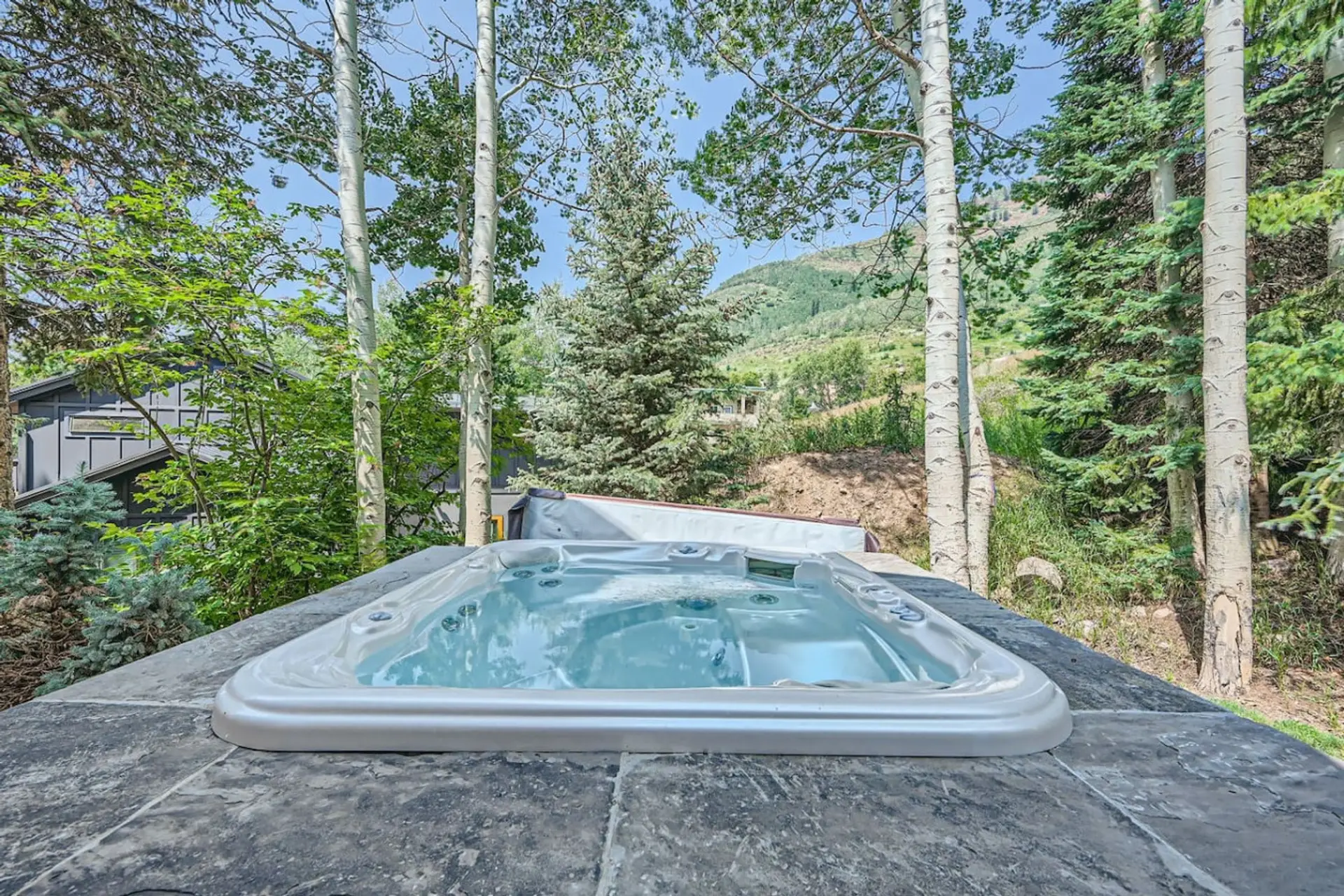 Enjoy a private outdoor hot tub just steps from your front door, complete with a heated walkway. Relax on your private patio while taking in the gentle mountain views—perfect for unwinding after a long day. Experience serenity at its best!