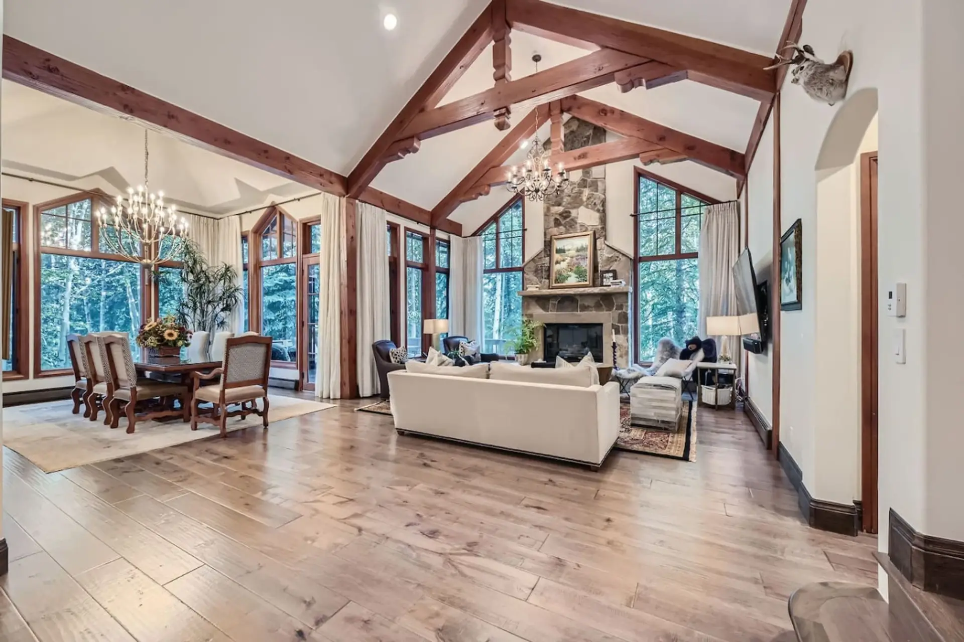 Relax in our spacious living room, where comfort meets elegance. Unwind by the cozy gas fireplace or step onto the private balcony, surrounded by luxurious seating and breathtaking mountain views. with easy access to the dining room/private balcony.