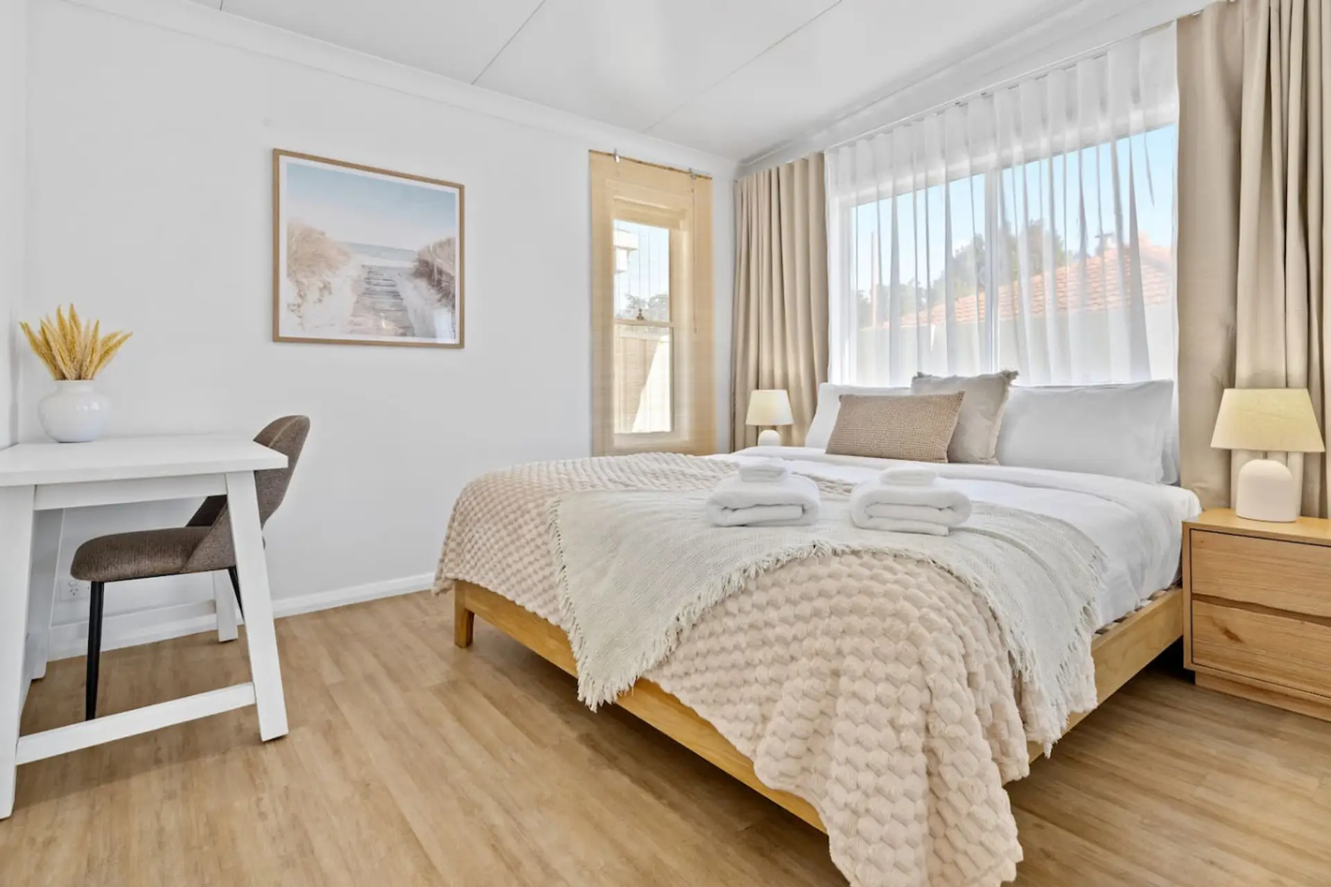 Main Bedroom with King bed, blockout curtains and a tucked-away work nook — ideal for couples, families or remote workers.