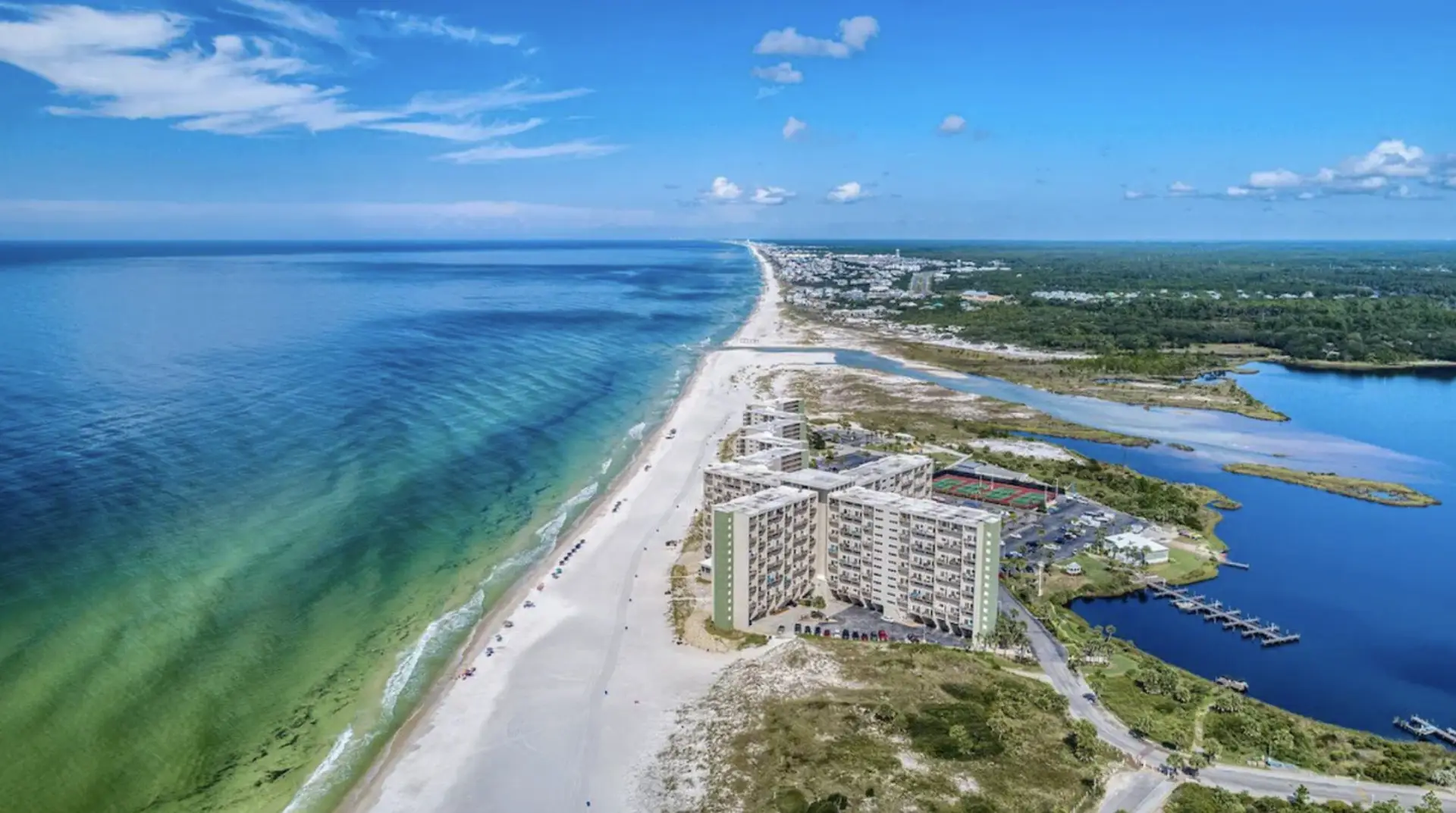 Aerial view of beachfront condo between Gulf and lake