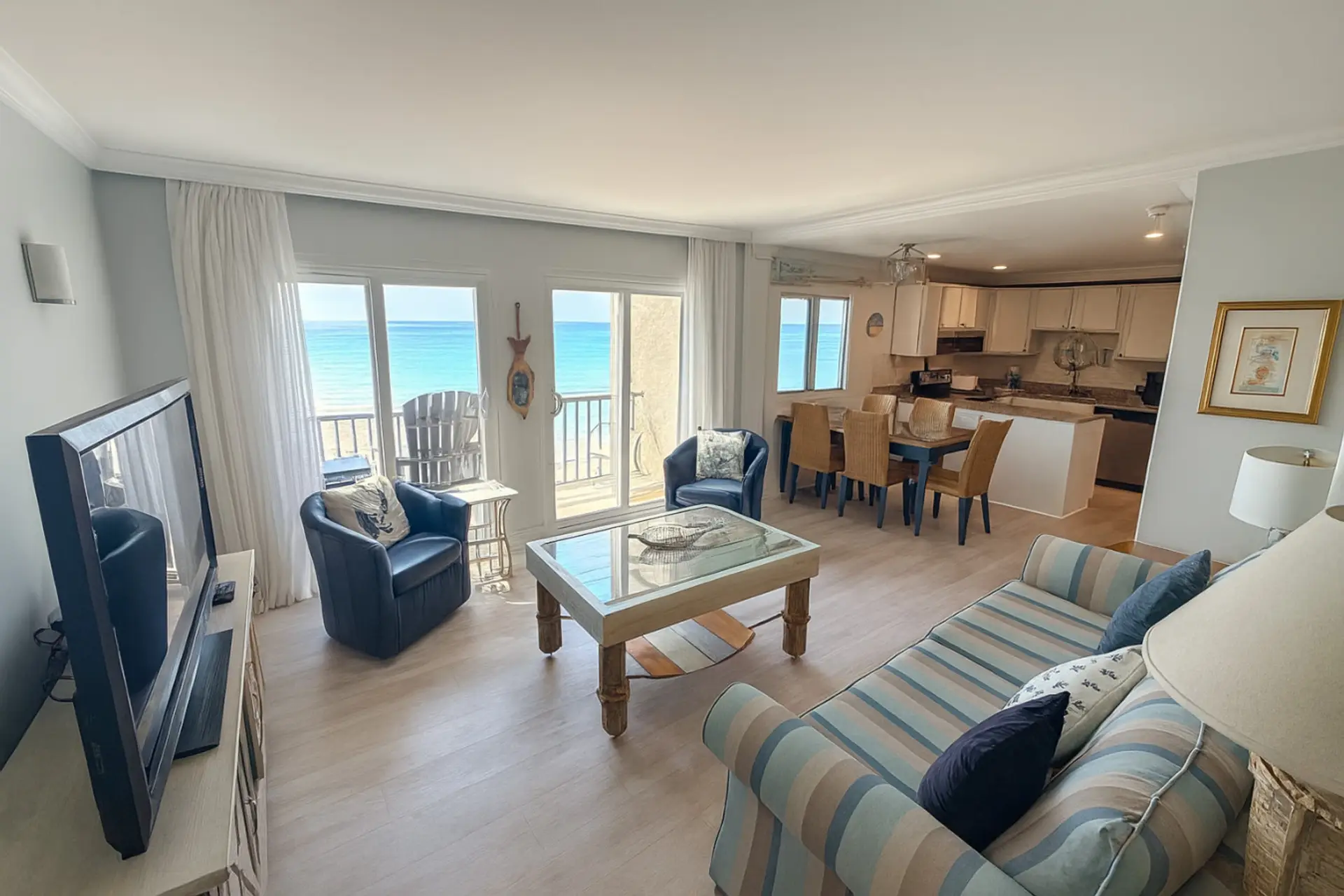 Open living room with balcony doors to turquoise Gulf