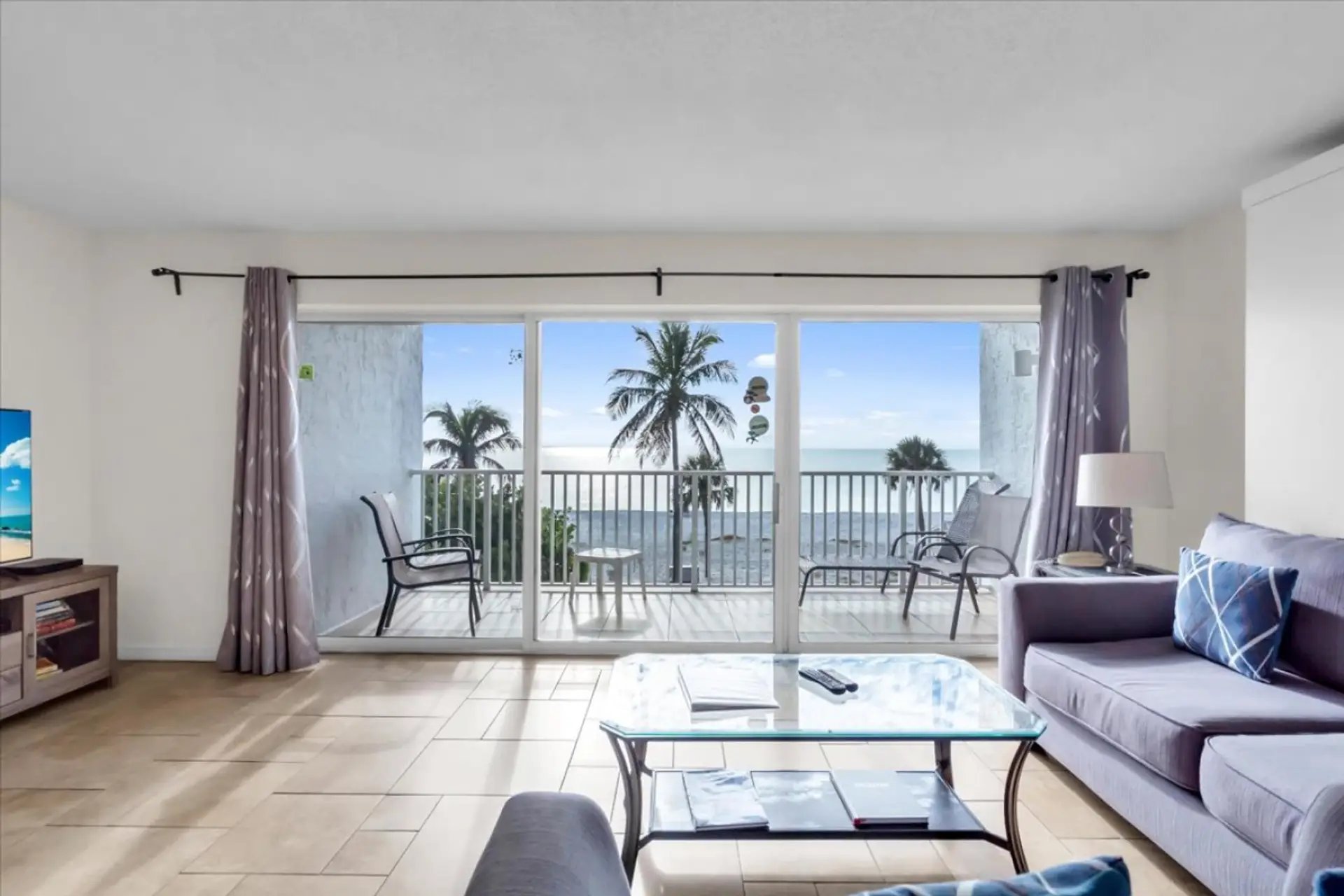 Comfortable living room with modern seating, natural light, and an open layout — ideal for relaxing during your Sarasota beach stay.