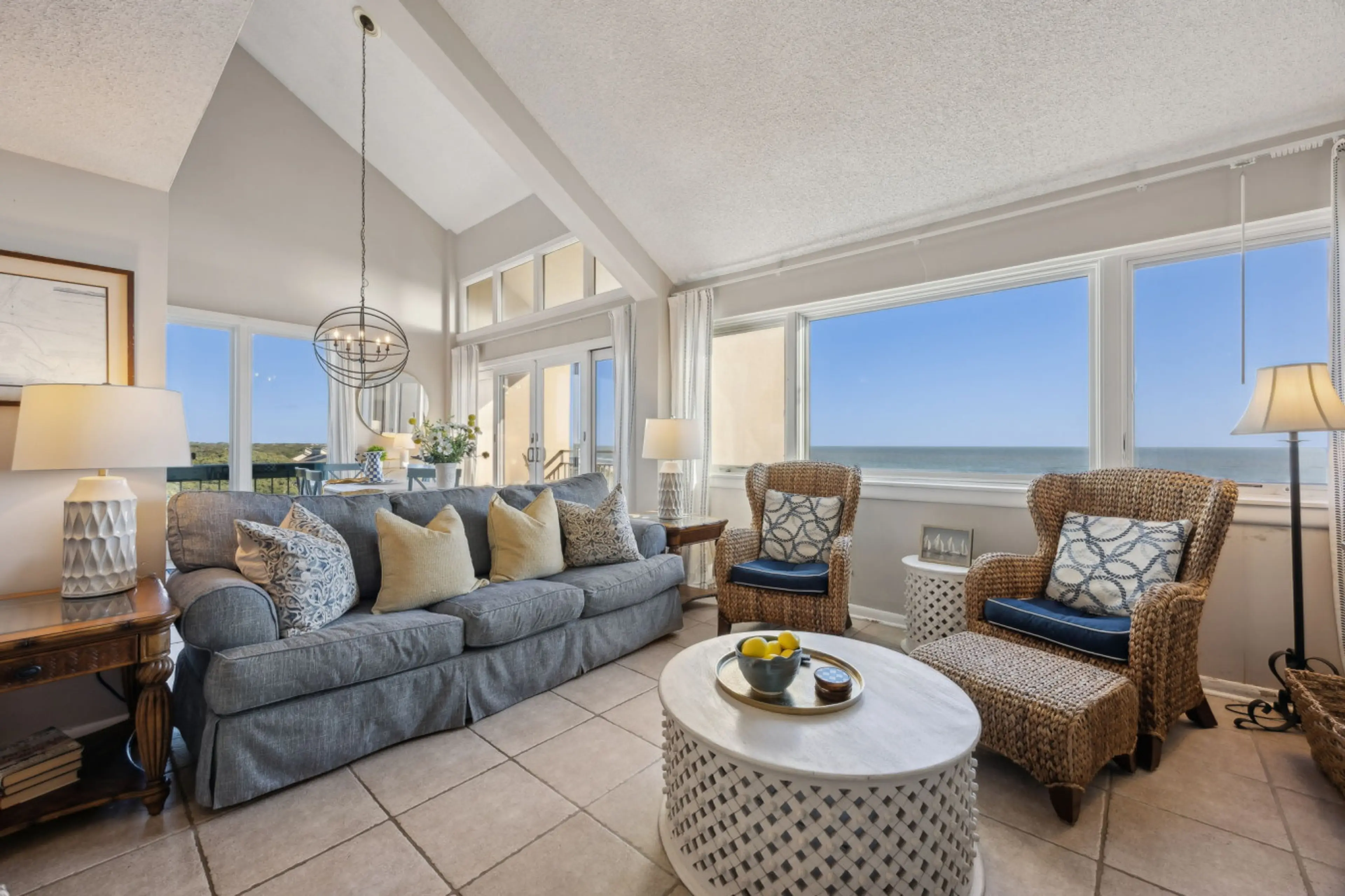 Bright, open-concept living space with stunning ocean views, coastal décor, and vaulted ceilings - A perfect Amelia Island Beach Vacation