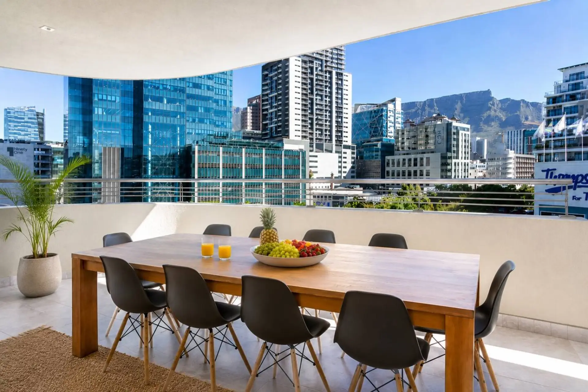 Mountain View Terrace: Spacious covered terrace with outdoor dining, offering a relaxed setting for alfresco meals while enjoying city skyline and mountain views.
