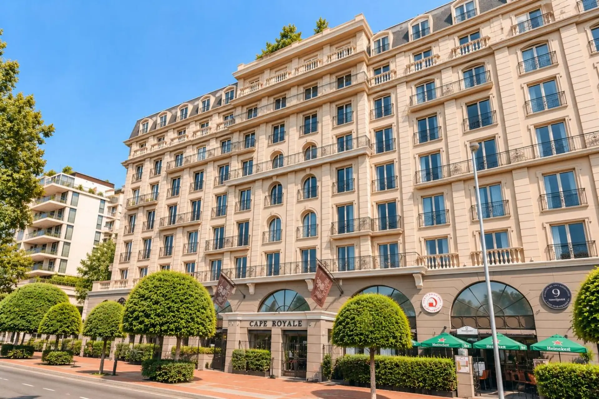 Cape Royale Exterior: Elegant European-inspired architecture rises above a tree-lined street, featuring classic balconies, arched windows, and a grand façade that creates an impressive welcome to this sophisticated Cape Town stay in Green Point View