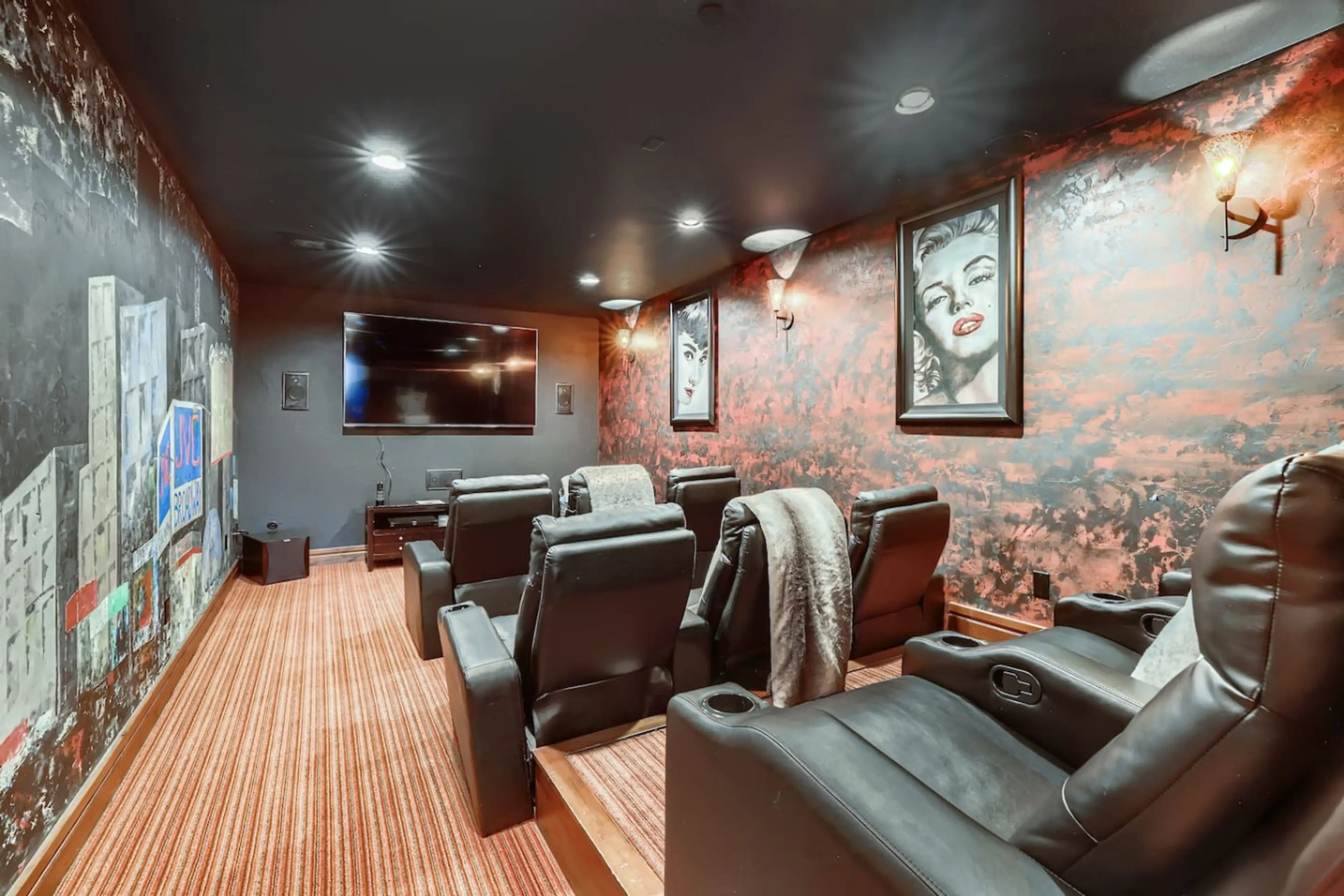 Enjoy a cinematic experience in the luxury home theater with plush seating and a large screen, perfect for family movie nights or gaming.
