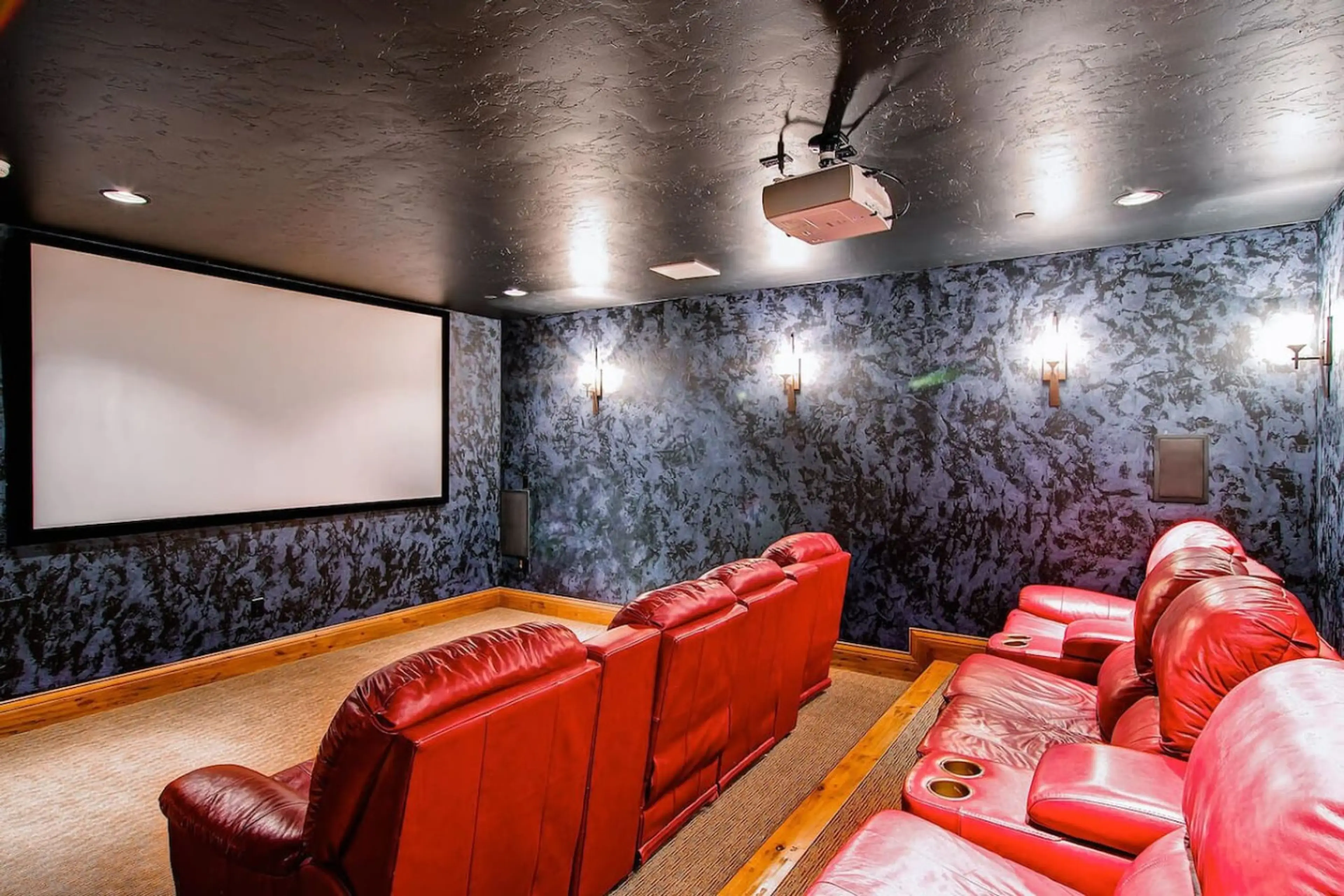Private home theater room with plush seating and a large projection screen, ideal for movie nights and entertainment with family and friends.