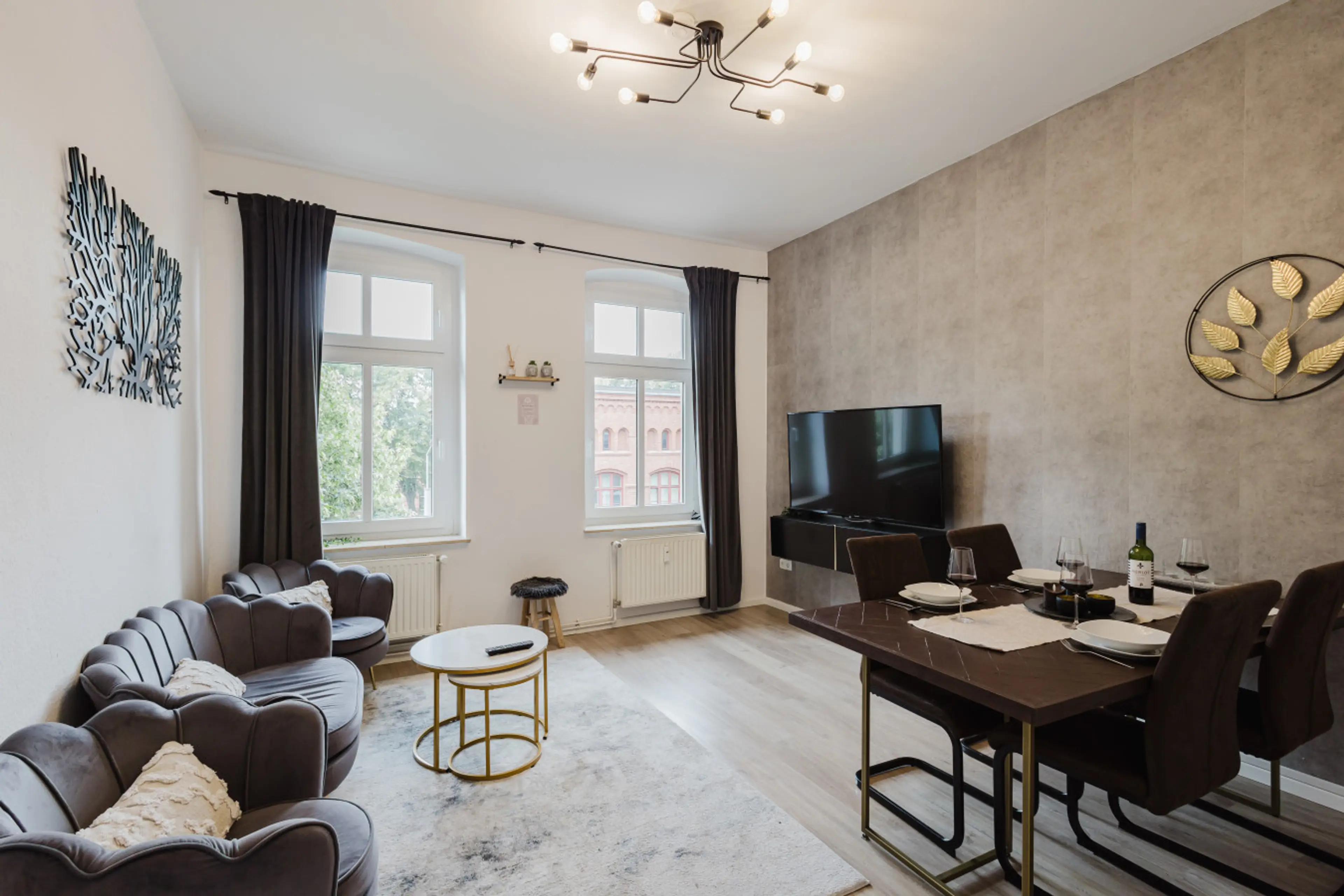 Spacious living and dining area with TV and elegant furniture.