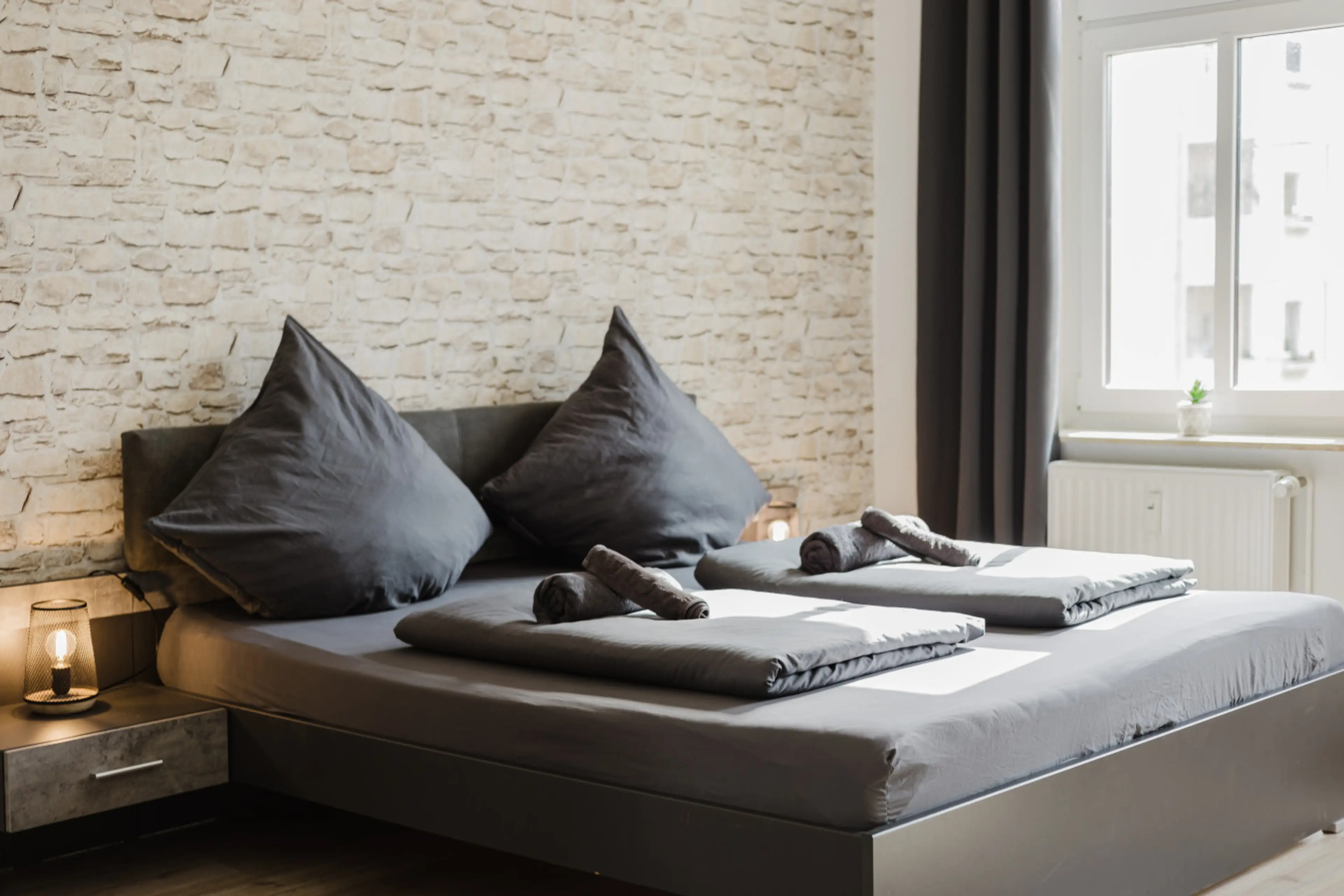 Bright bedroom flooded with daylight – your oasis of calm in the city.