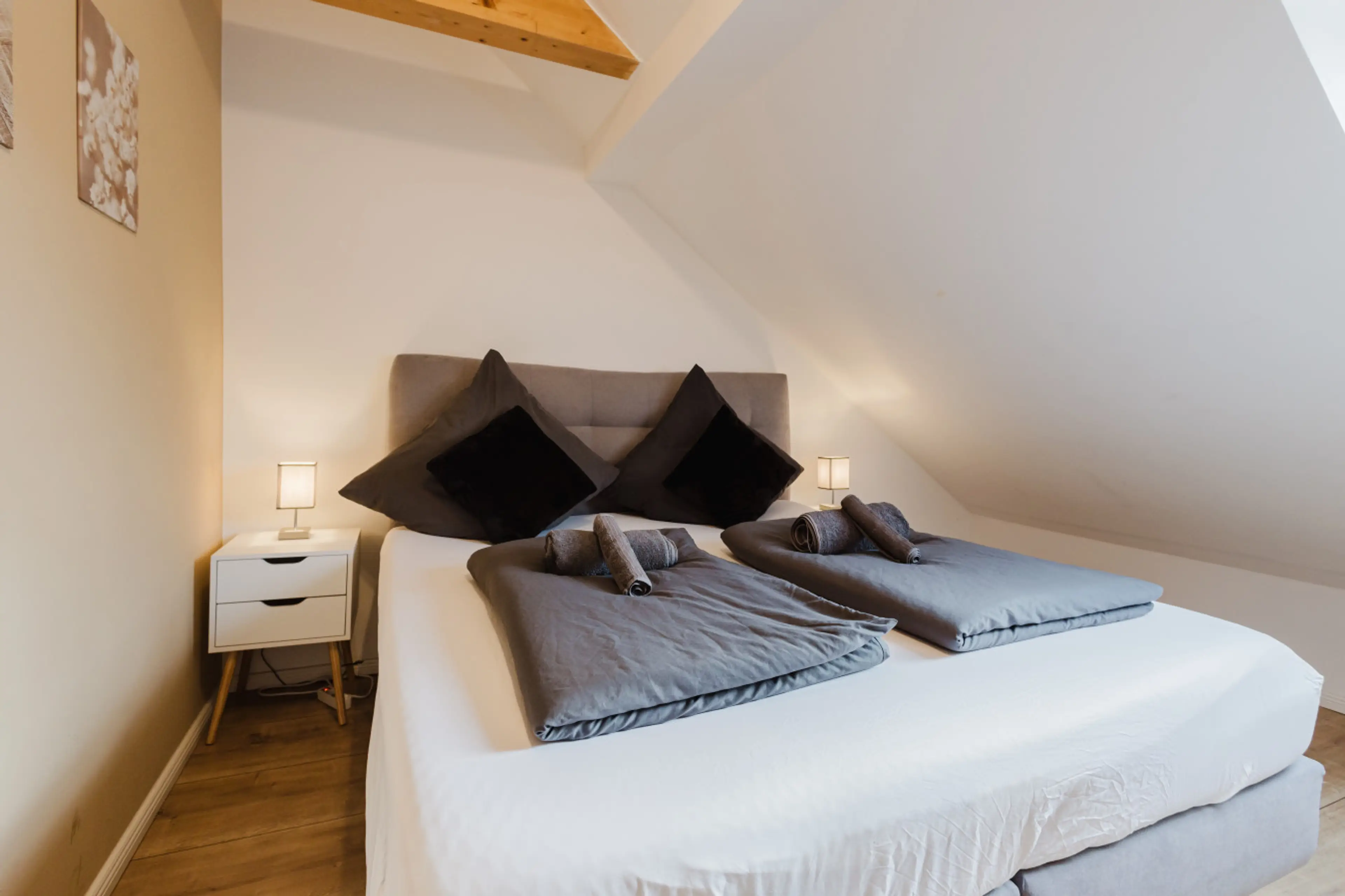 Tranquil double bedroom with ambient lighting and soft bedding.