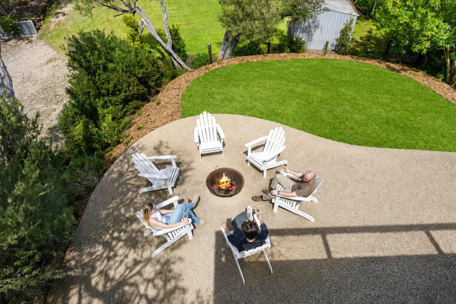 Wide lawn and chairs made for marshmallows, stories and a good red.