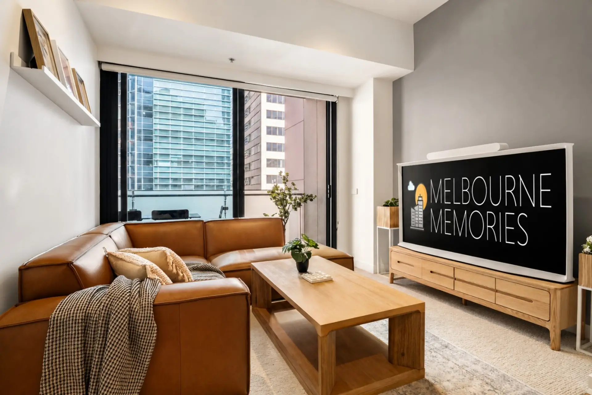 Stylish CBD living space featuring a cozy lounge and stunning city views.
