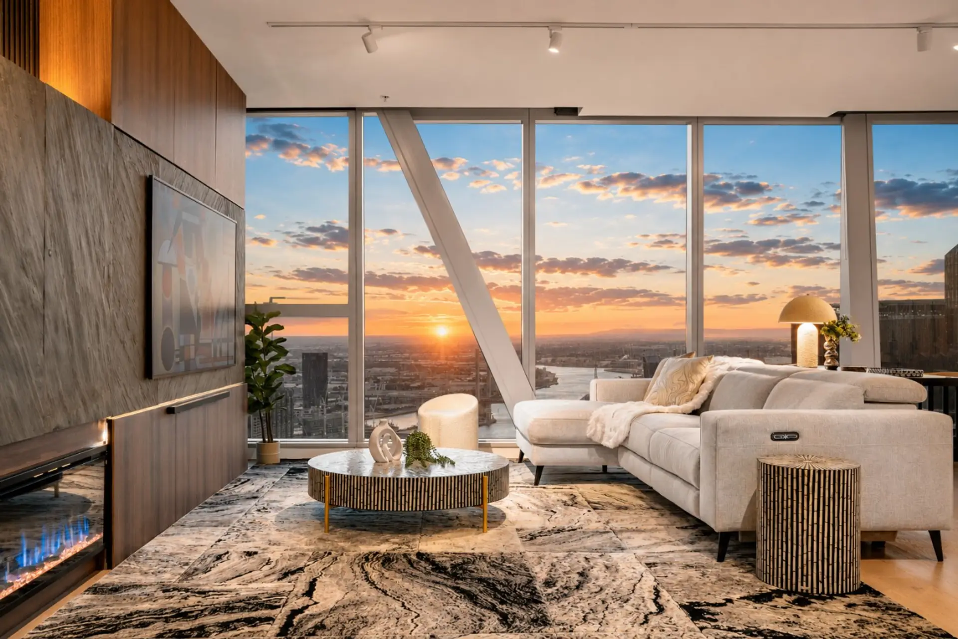 Spacious and modern living area, offering stunning sunset views over the city skyline.