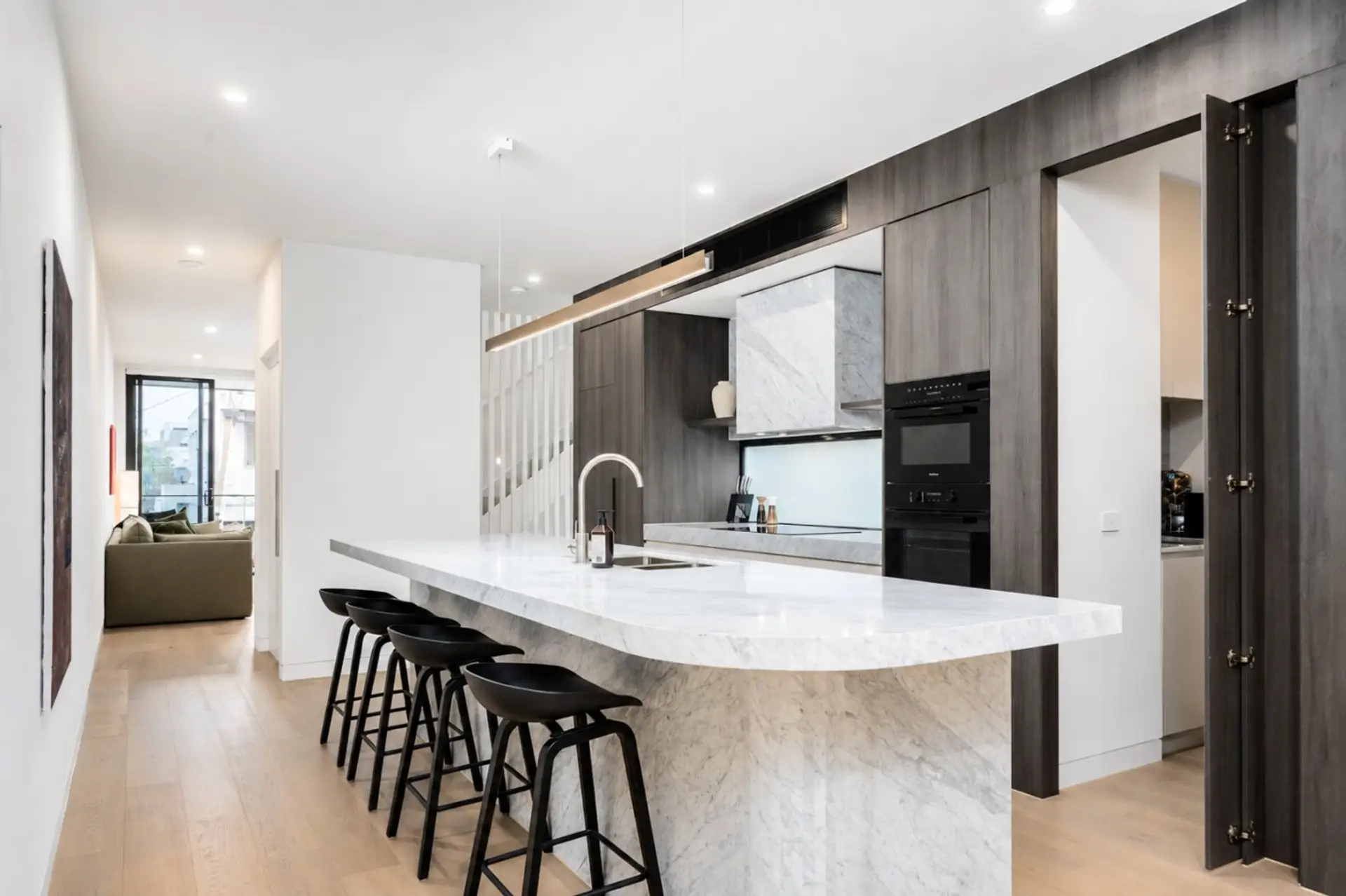 An expansive marble island offers generous space for cooking, dining and conversation