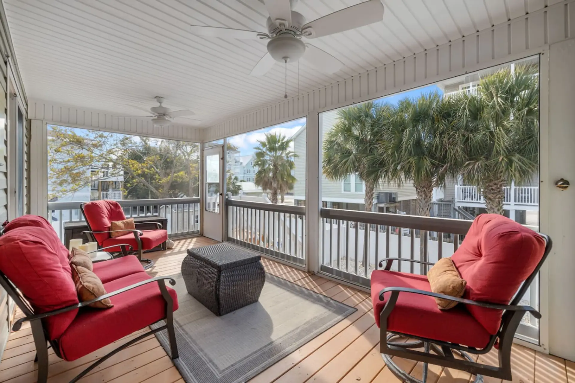 Large screened-in porch with comfortable outdoor rocking chairs.