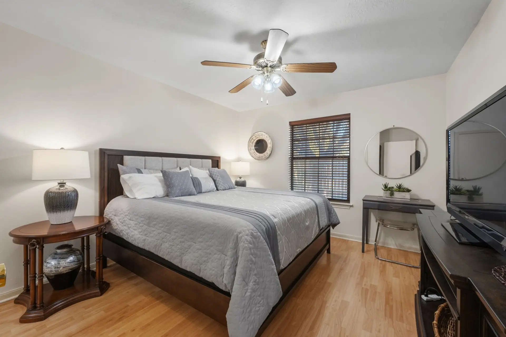 A king-size bed, bedside lamps, and a TV in bedroom 1.