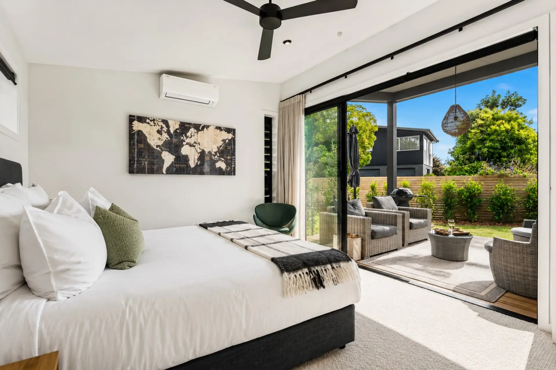 Each bedroom opens onto the outdoors through large sliding doors, creating a seamless connection to the garden and outdoor living spaces.