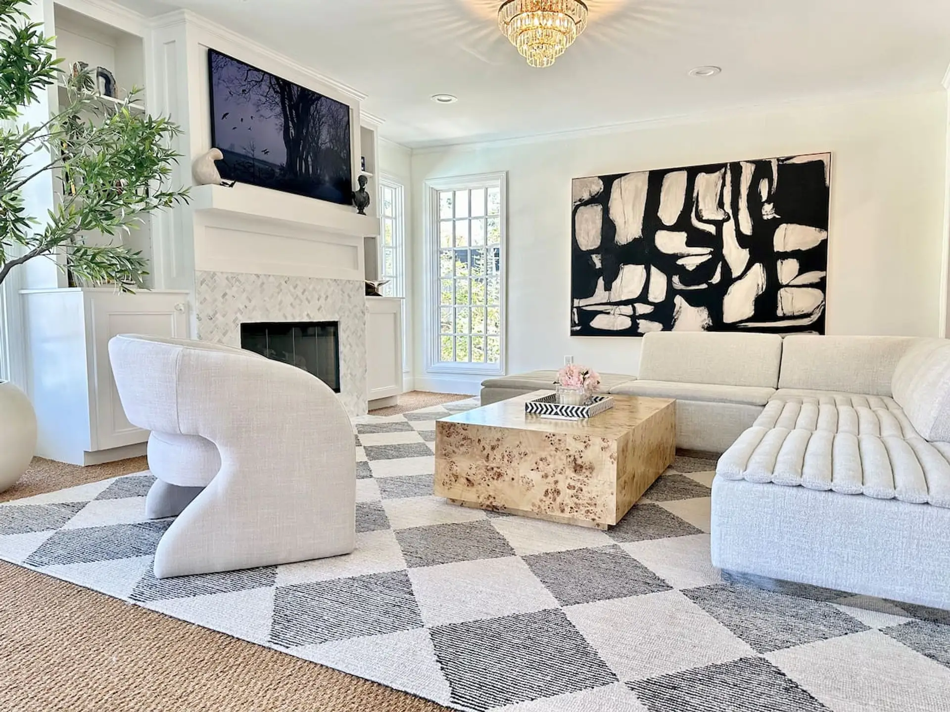 Bright and spacious living room with comfortable seating, a Smart TV, and plenty of natural light.