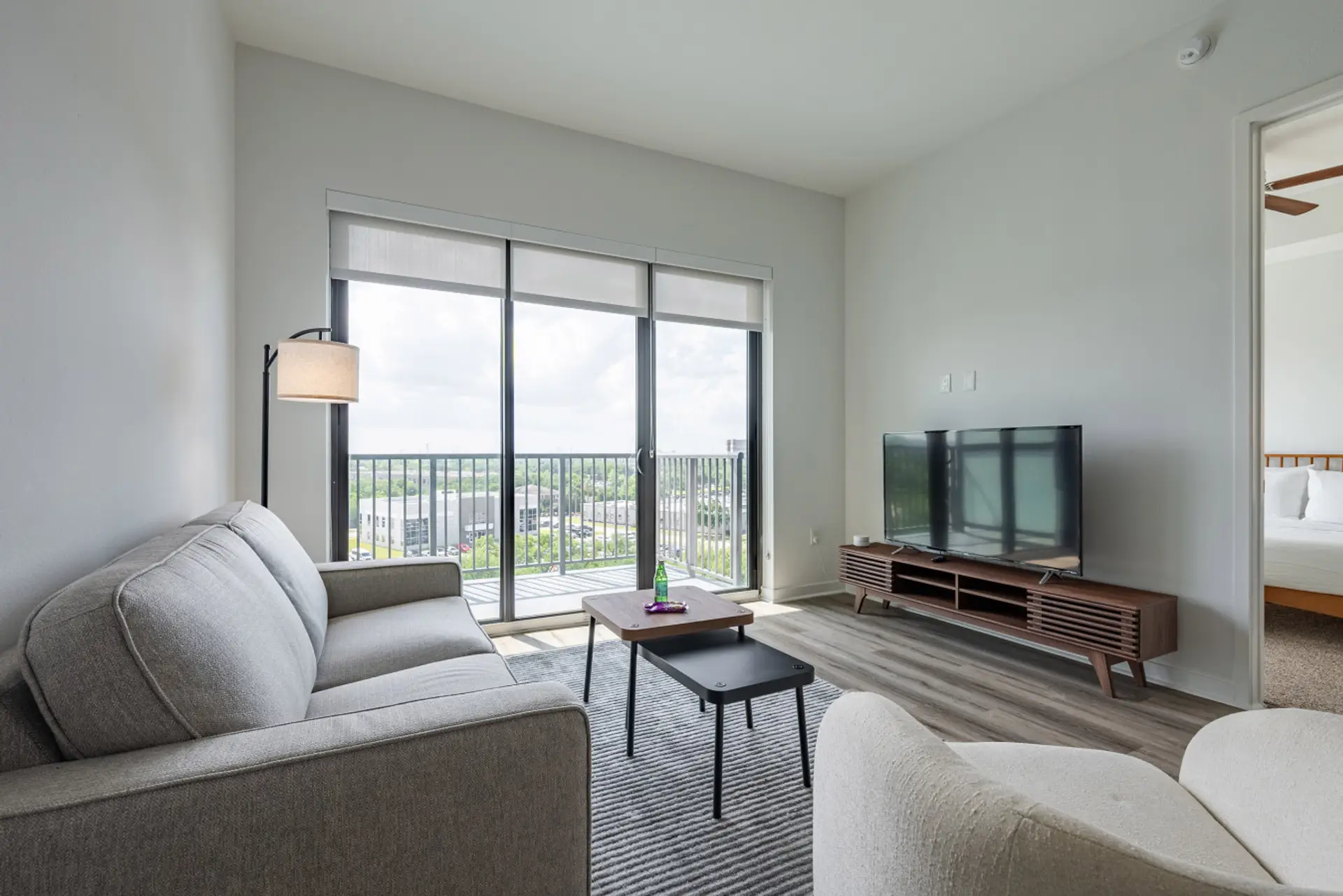 Relaxing living space with modern furnishings and balcony.