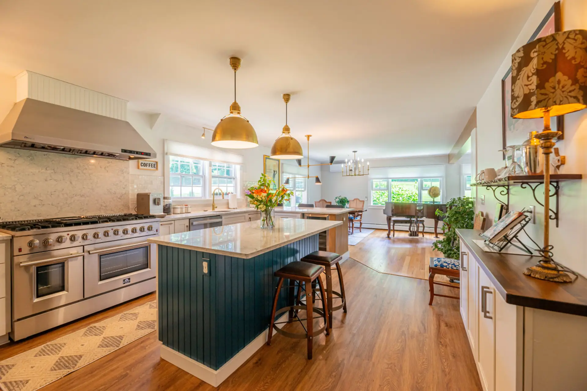 Enjoy this spacious, sun-filled kitchen, featuring top-of-the-line appliances, a gorgeous marble island, and chic pendant lighting.