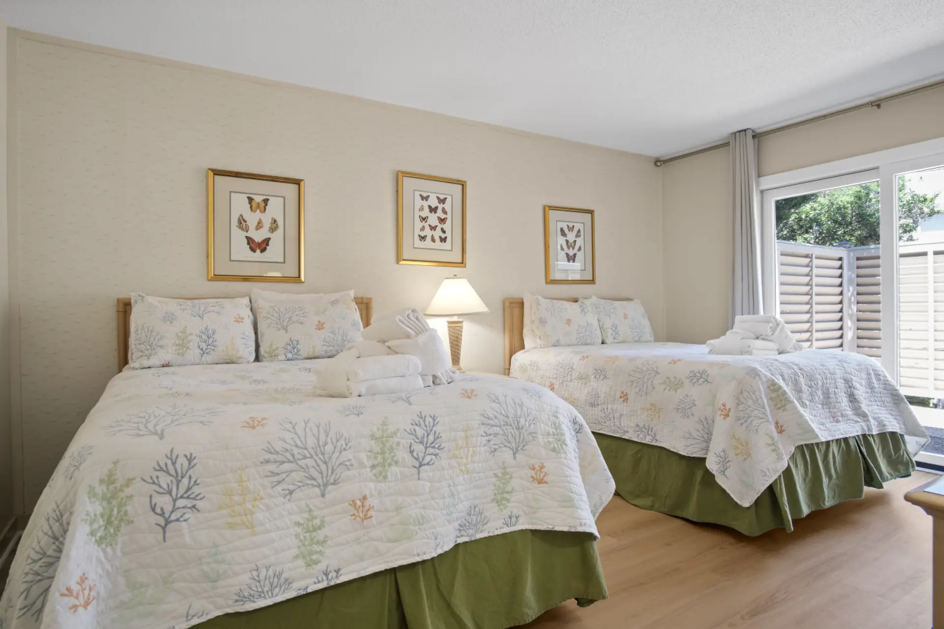 Downstairs primary suite featuring two full beds, TV entertainment, and direct courtyard access for added privacy and convenience.