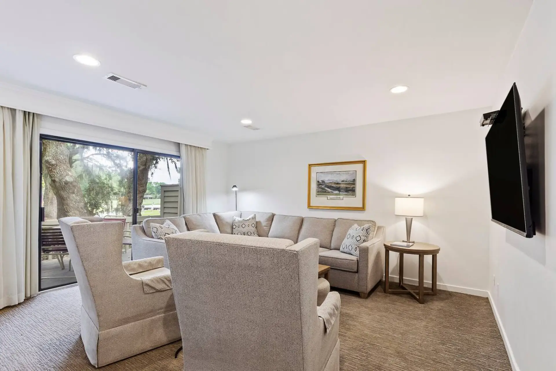 Comfortable swivel chairs provide additional seating in the open living area, creating a welcoming space for conversation, reading, or relaxing.