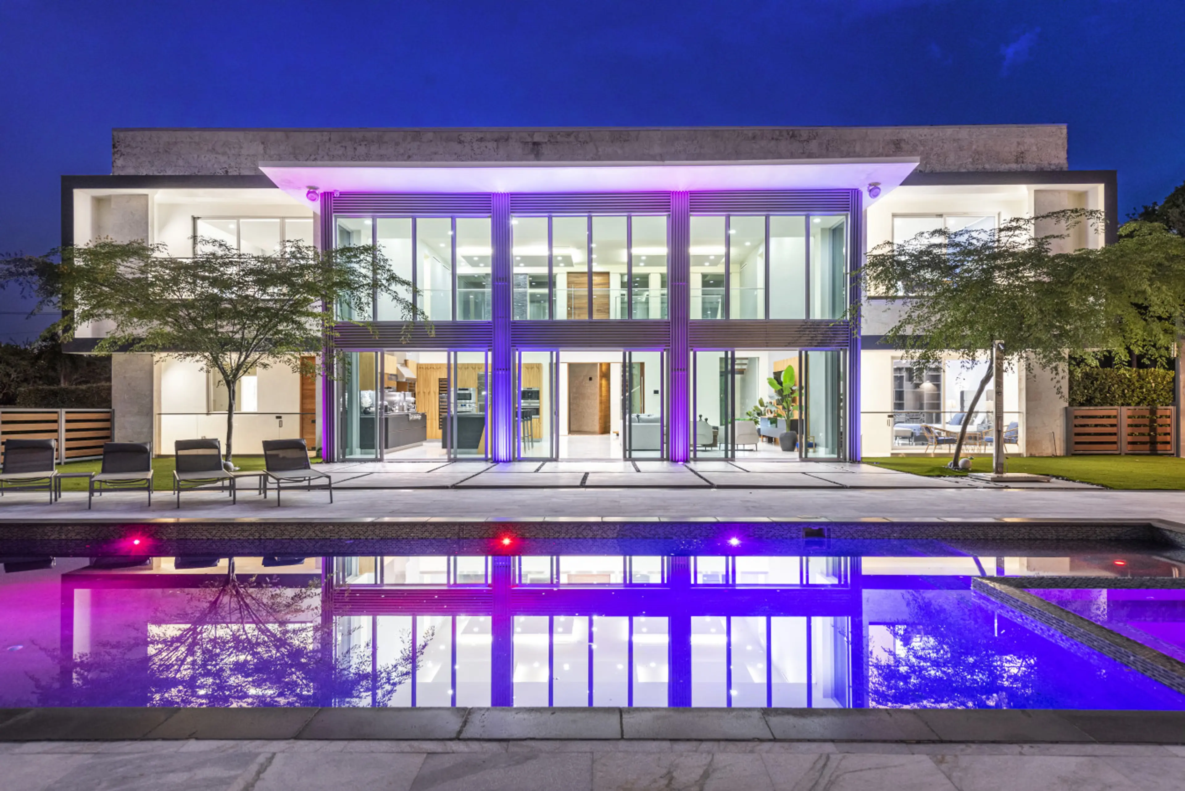 Glass front luxury villa with private, mood lit pool and loungers for unforgettable evenings