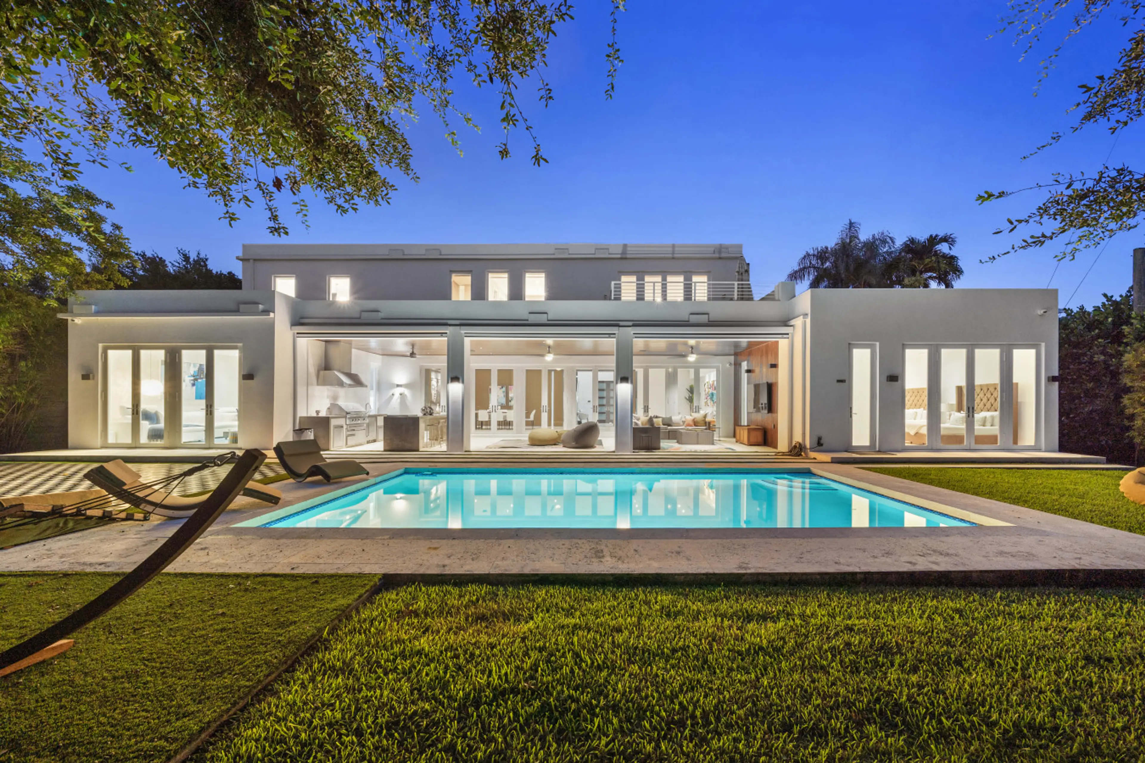 Grand outdoor swimming pool with night lighting and serene setting