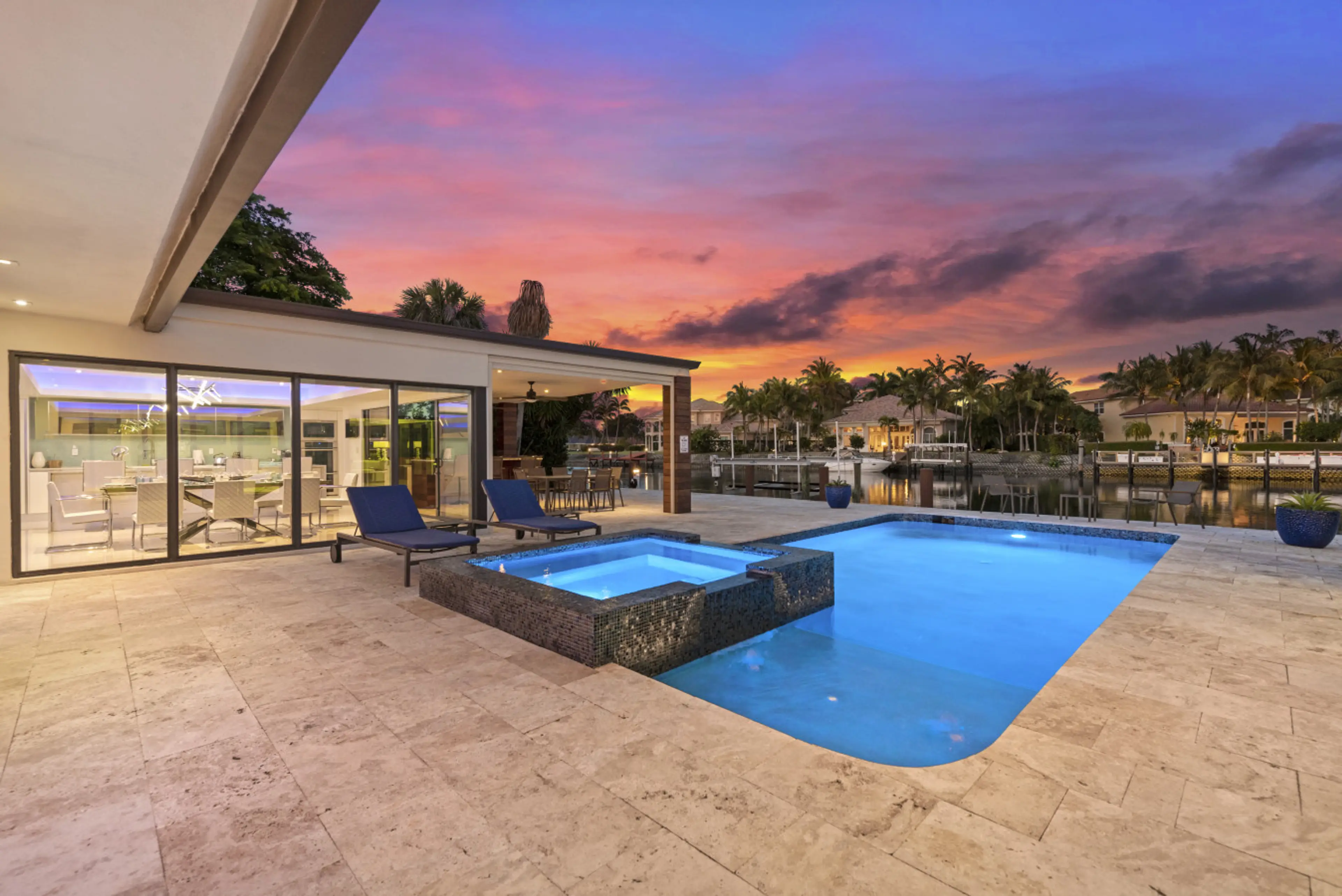 Scenic pool patio with built in spa comfy chairs and beautiful sunset backdrop