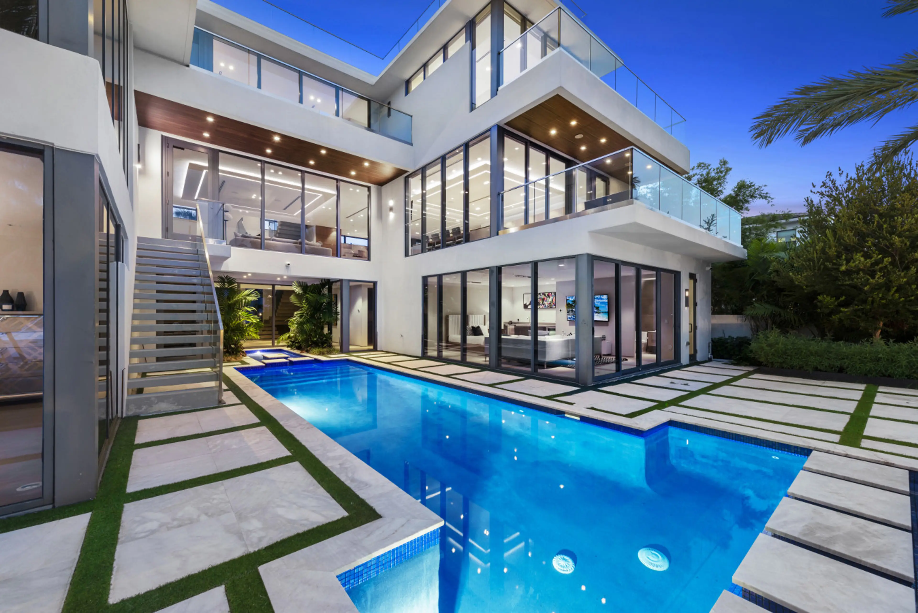 View of the multi-level terrace and private pool, highlighting the property's indoor-outdoor living concept and modern design.