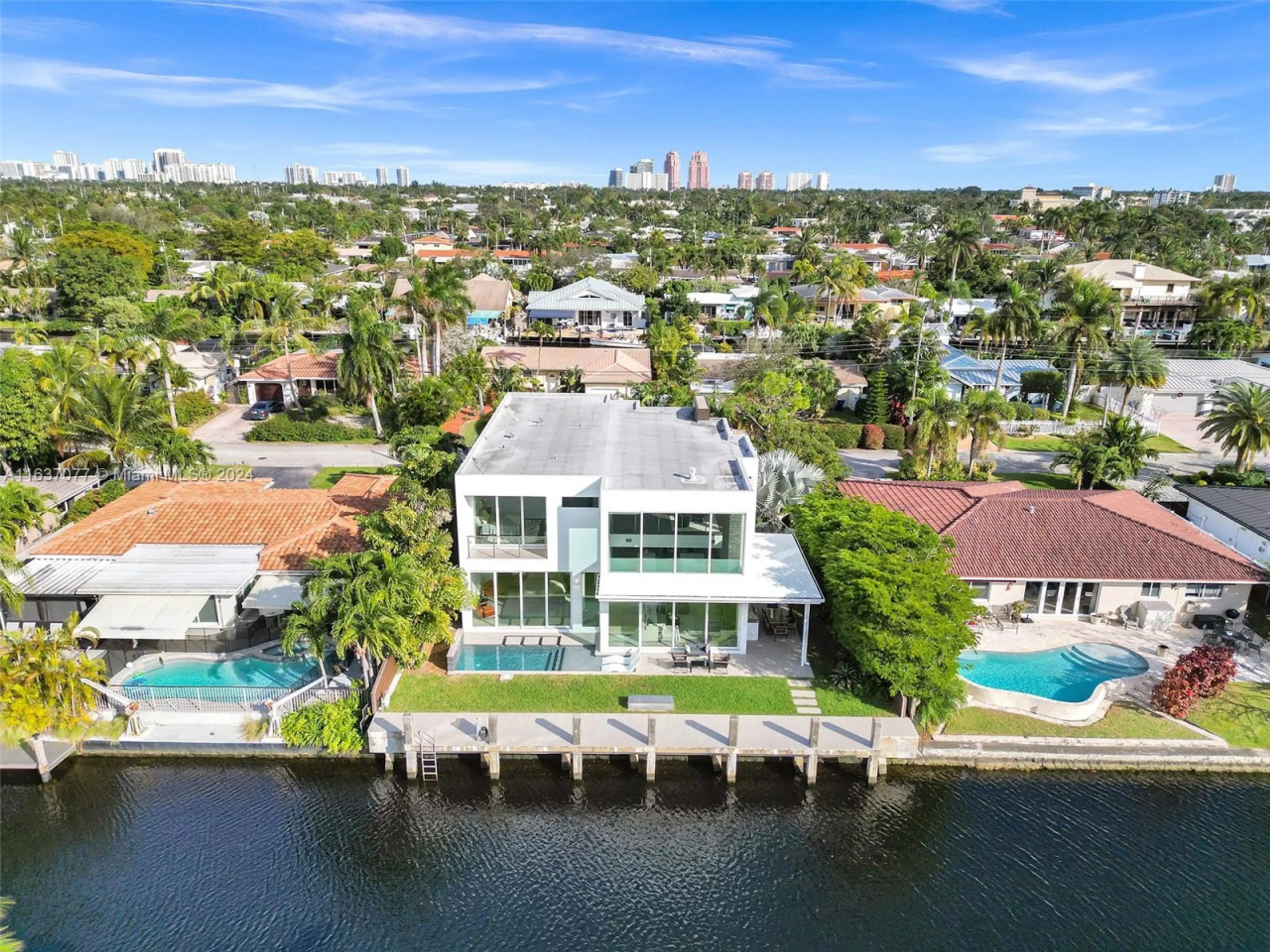 Breathtaking waterfront estate combining architectural excellence with spectacular pool amenities and premium marina access