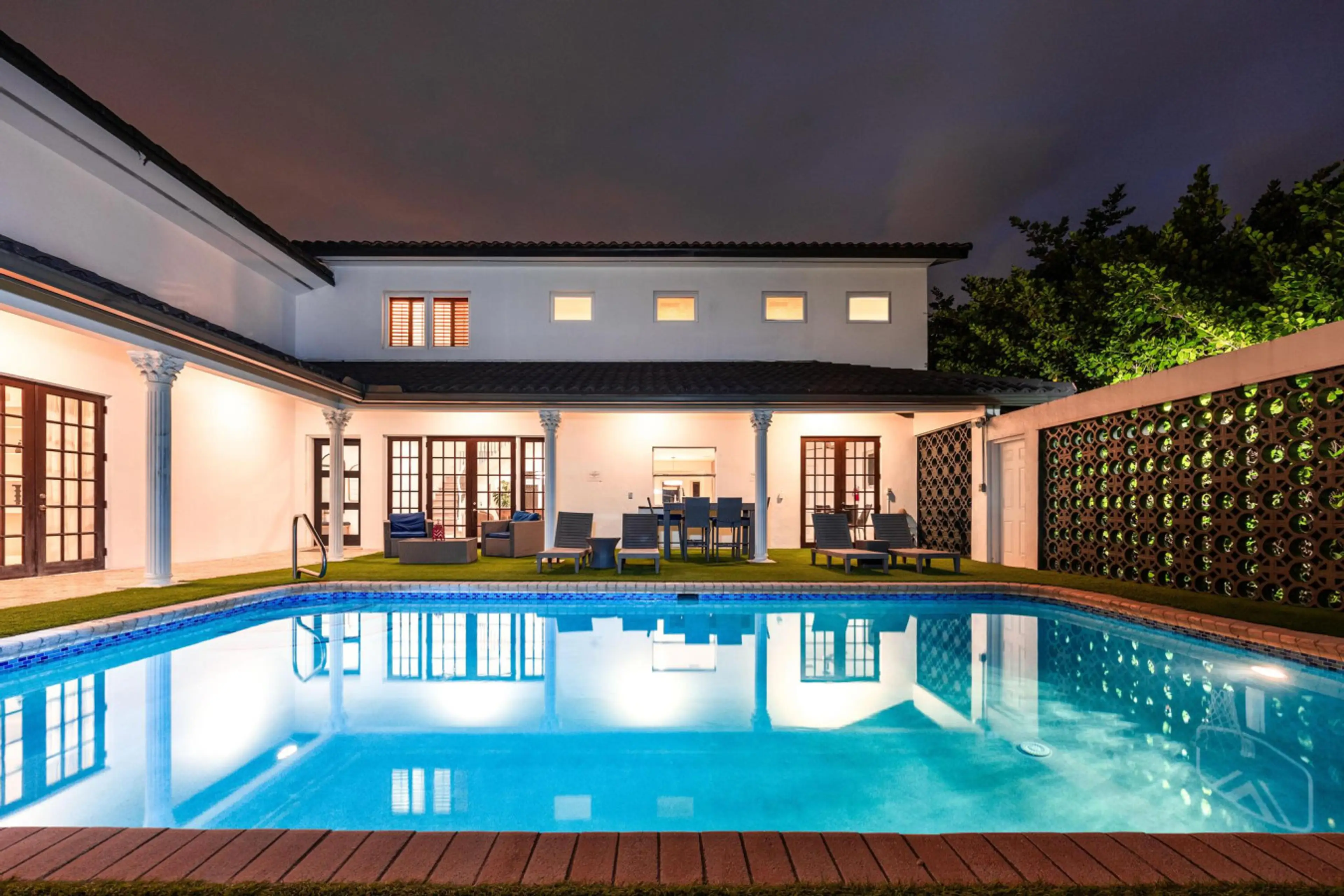Modern architectural masterpiece with pristine pool area and magnificent twilight garden views