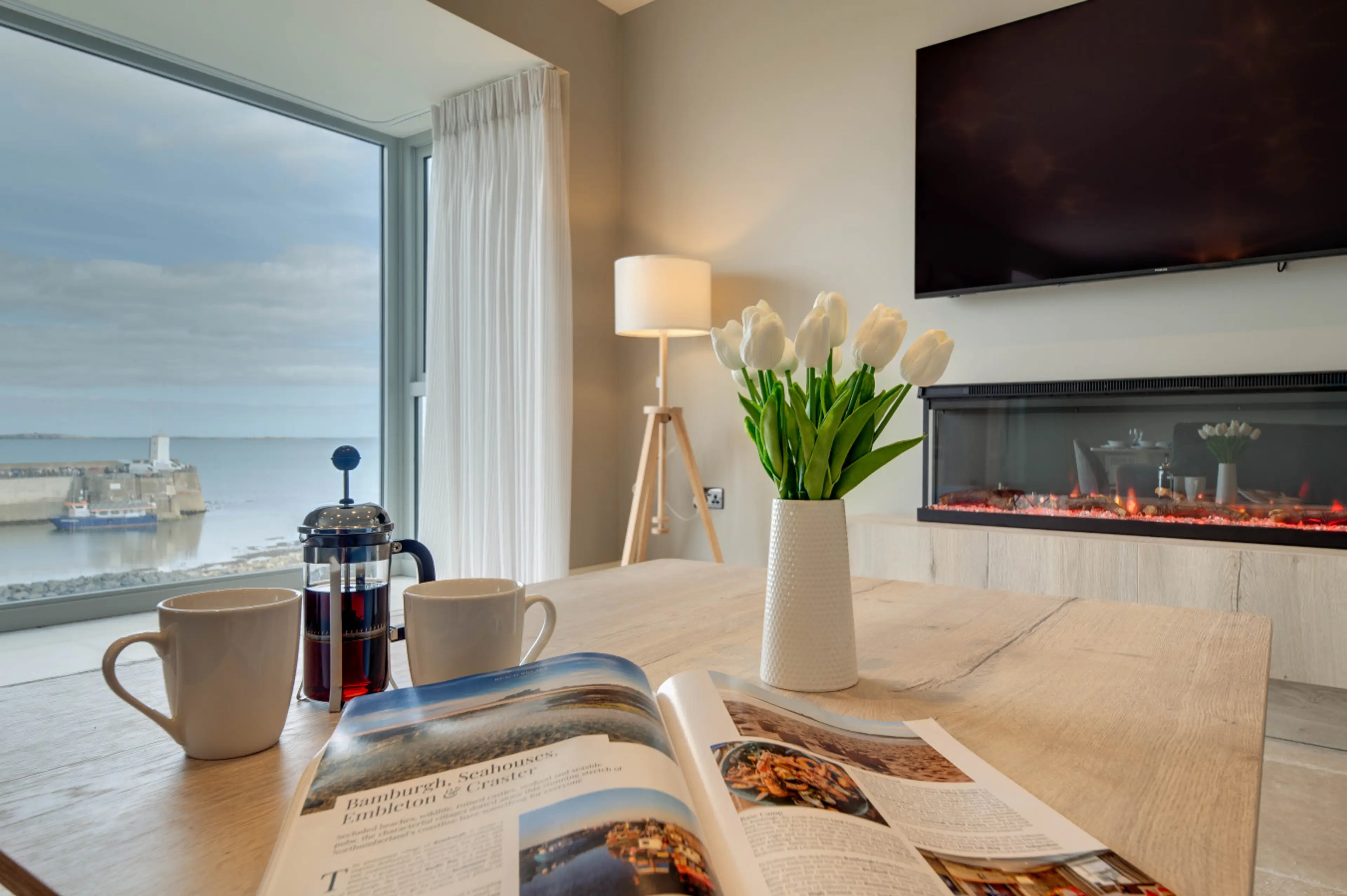 Lounge with fireplace and panoramic sea views