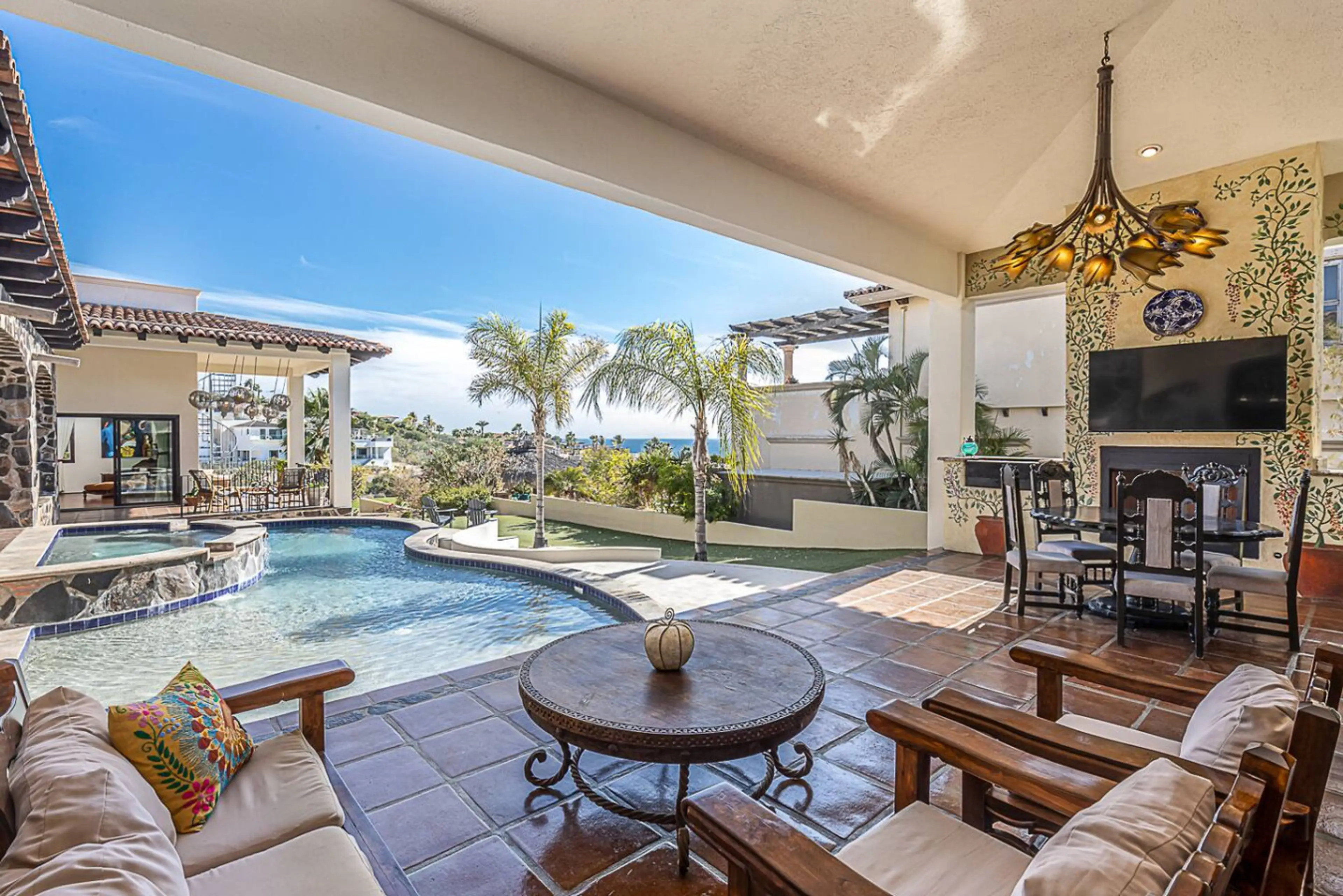 Spacious terrace featuring an outdoor dining area, lounge seating, charcoal grill, and TV — perfect for relaxing and enjoying the outdoors.