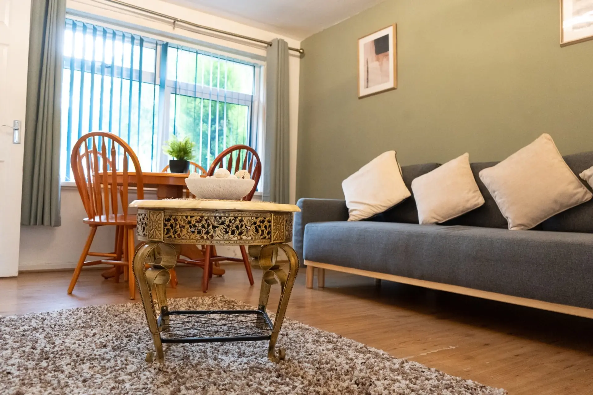 Bright living room with sofa, dining table and large window