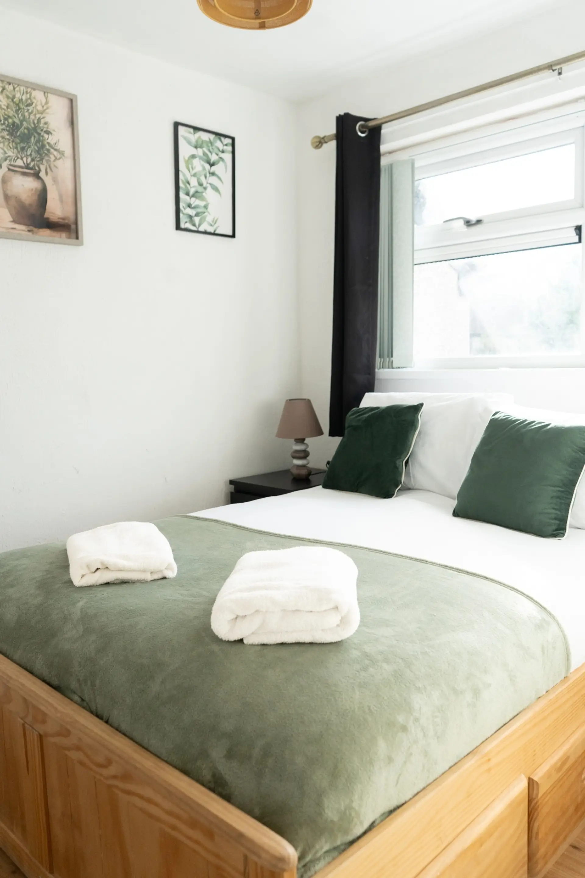 Double bedroom with green bedding and fresh towels