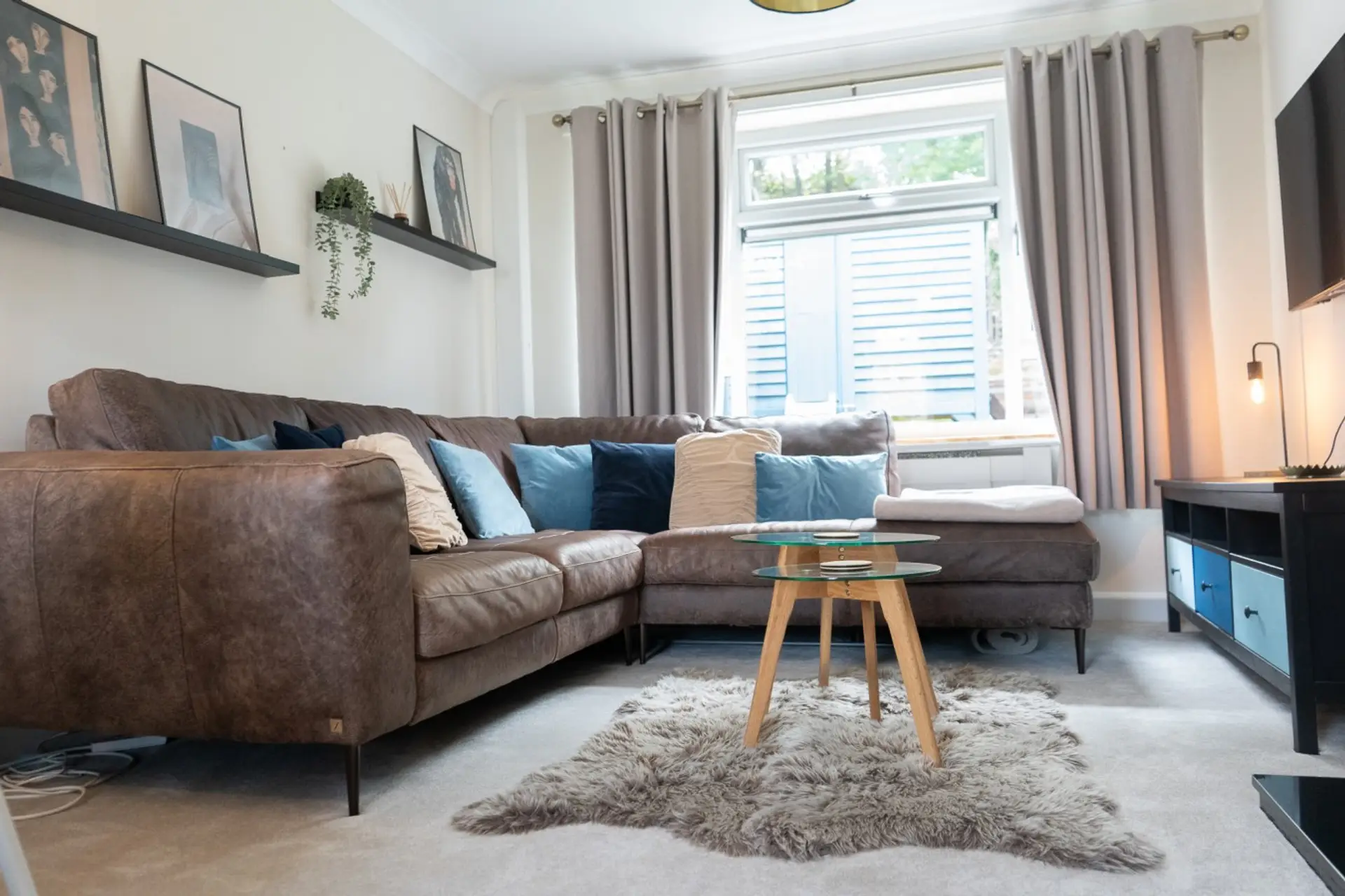 Bright living room with large corner sofa and TV