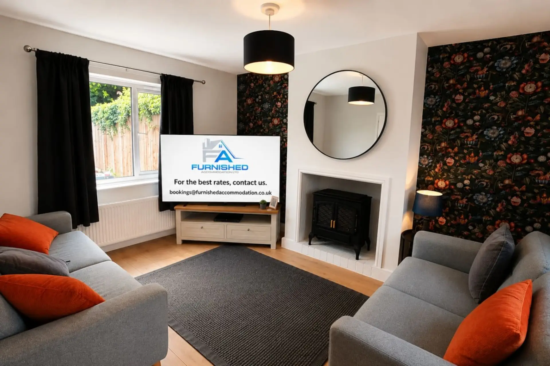 Living room with grey sofas, TV and feature fireplace